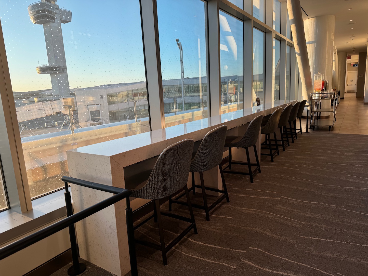 a row of chairs in a room with windows