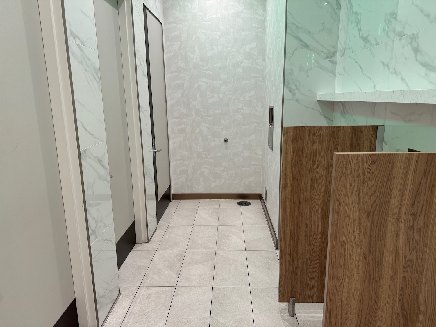 a bathroom with marble walls and doors