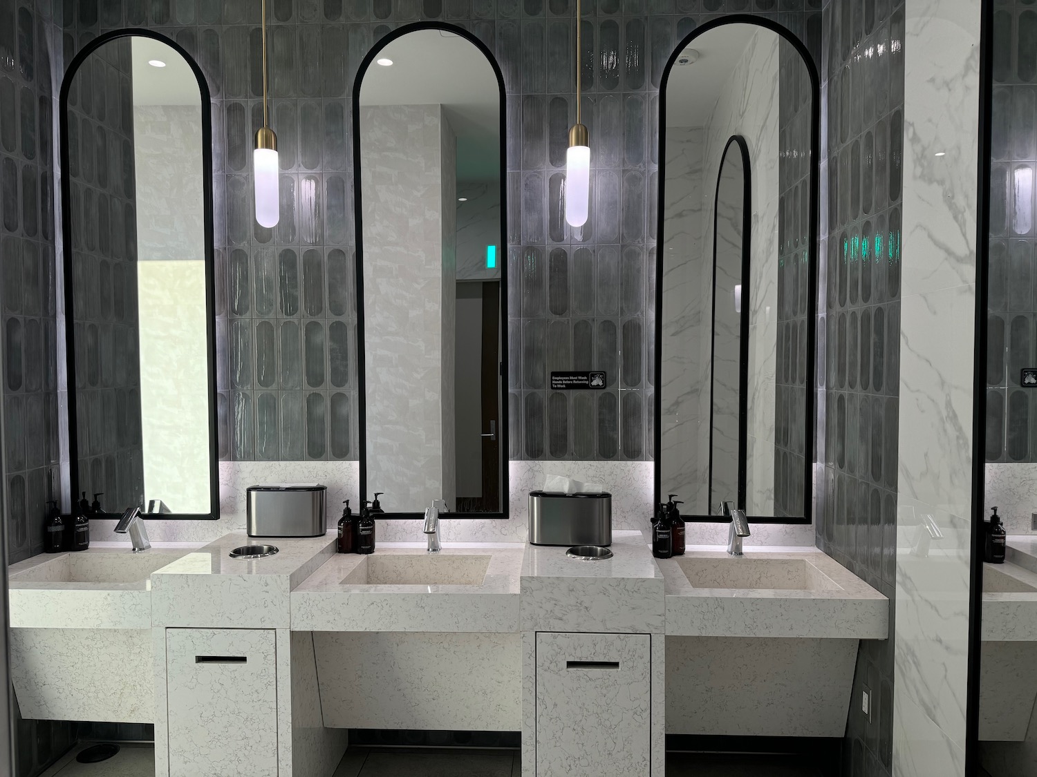 a bathroom with sinks and mirrors