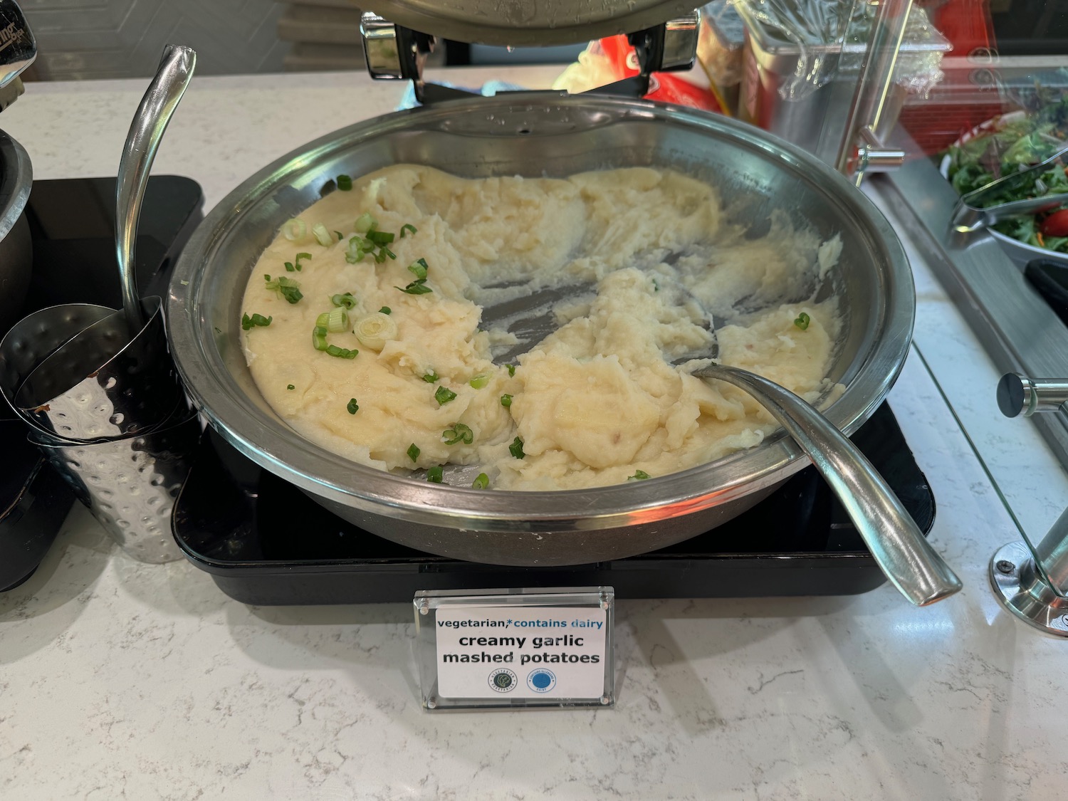 a bowl of mashed potatoes with green onions