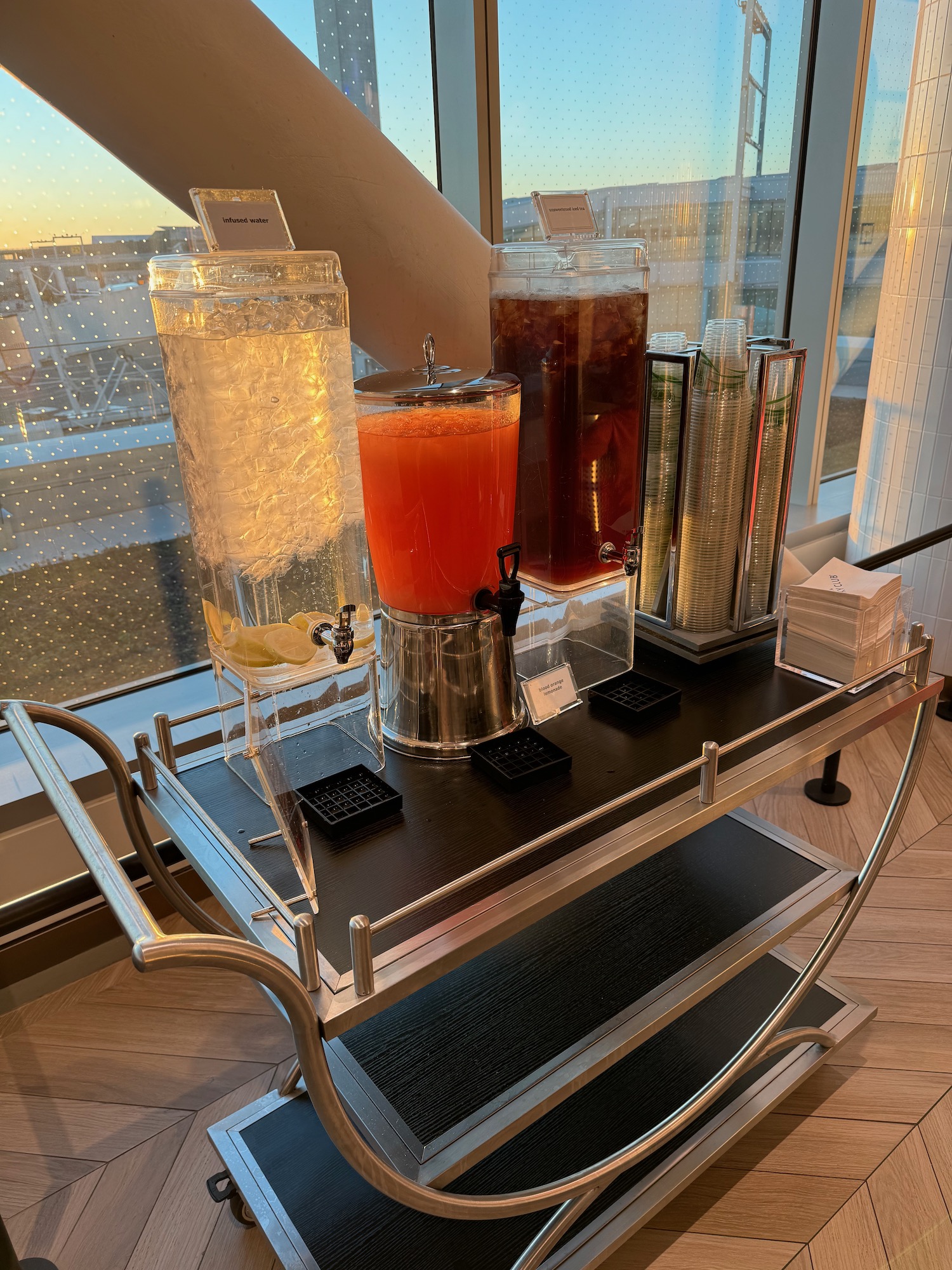 a beverage dispenser with different types of liquid on a table