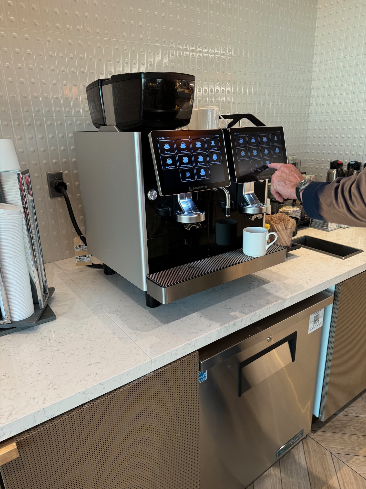 a person using a coffee machine