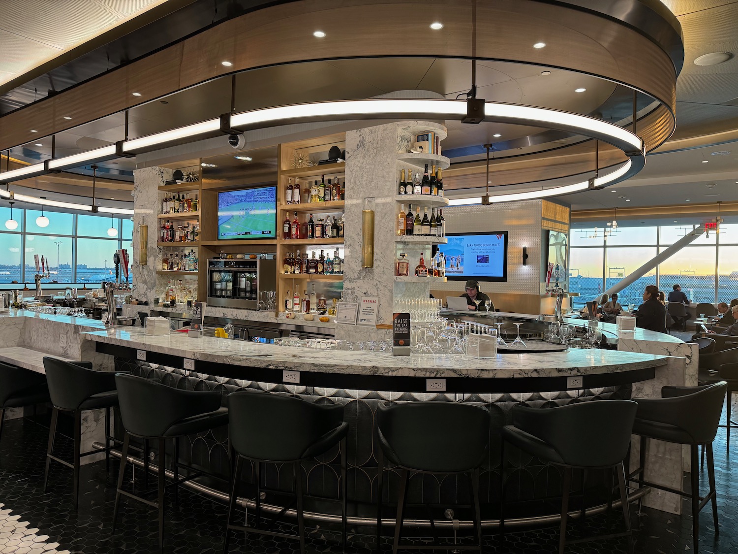 a bar with a counter and chairs