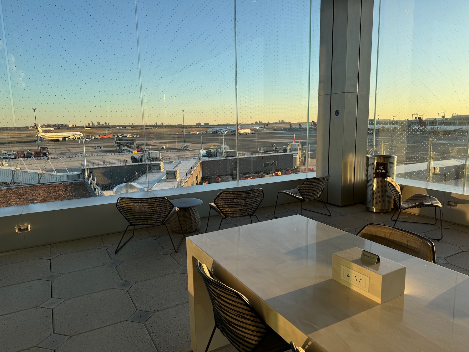 a room with a table and chairs and a large window