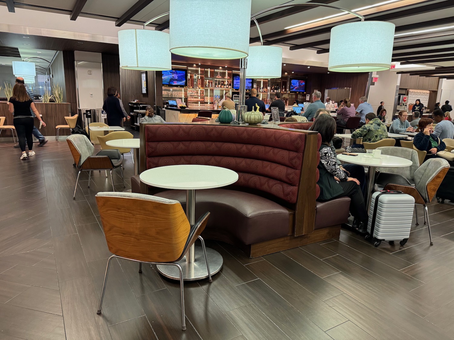 a group of people sitting at tables in a restaurant