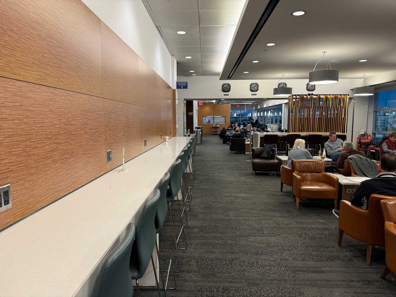 people sitting in a room with chairs and tables