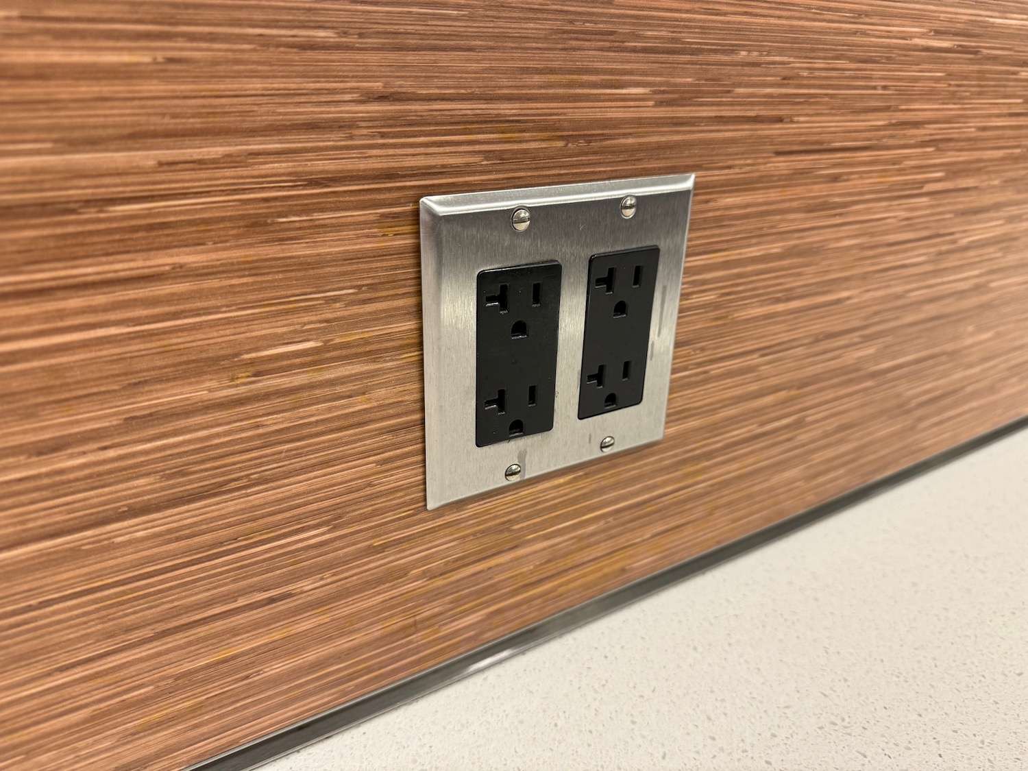 a wall outlet with black and silver plugs