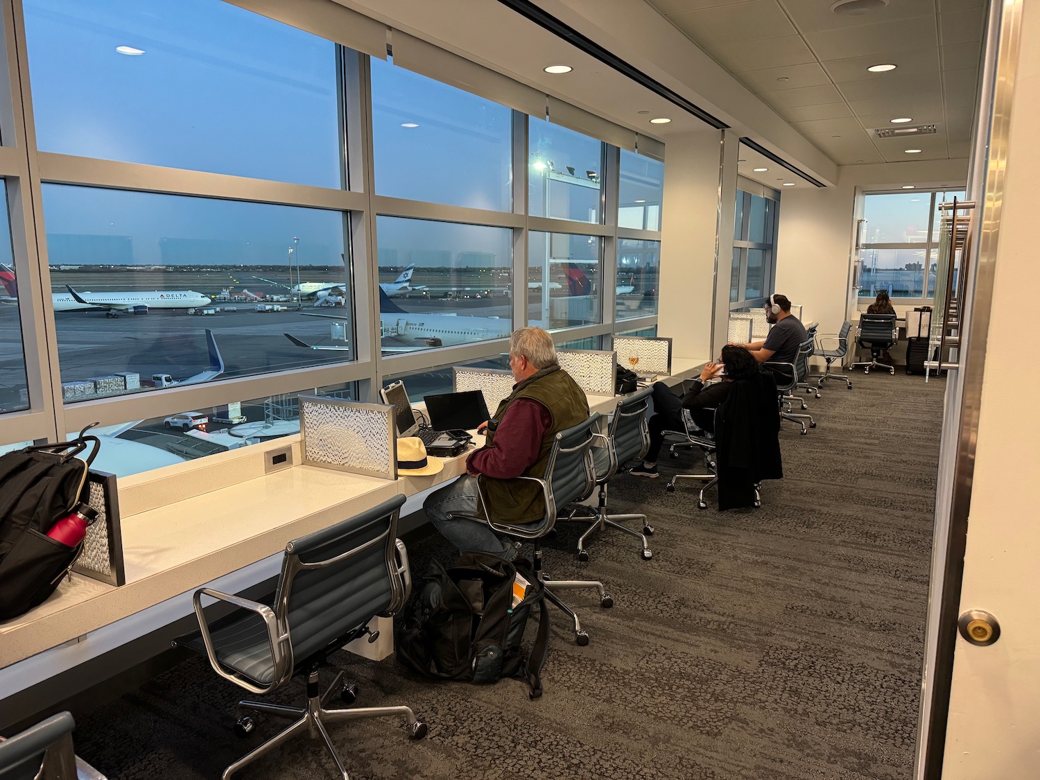 people sitting in chairs in an airport