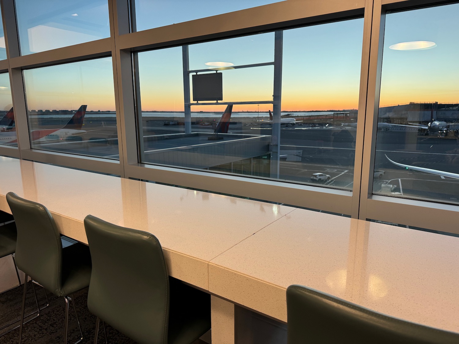 a window with a view of an airport and an airplane