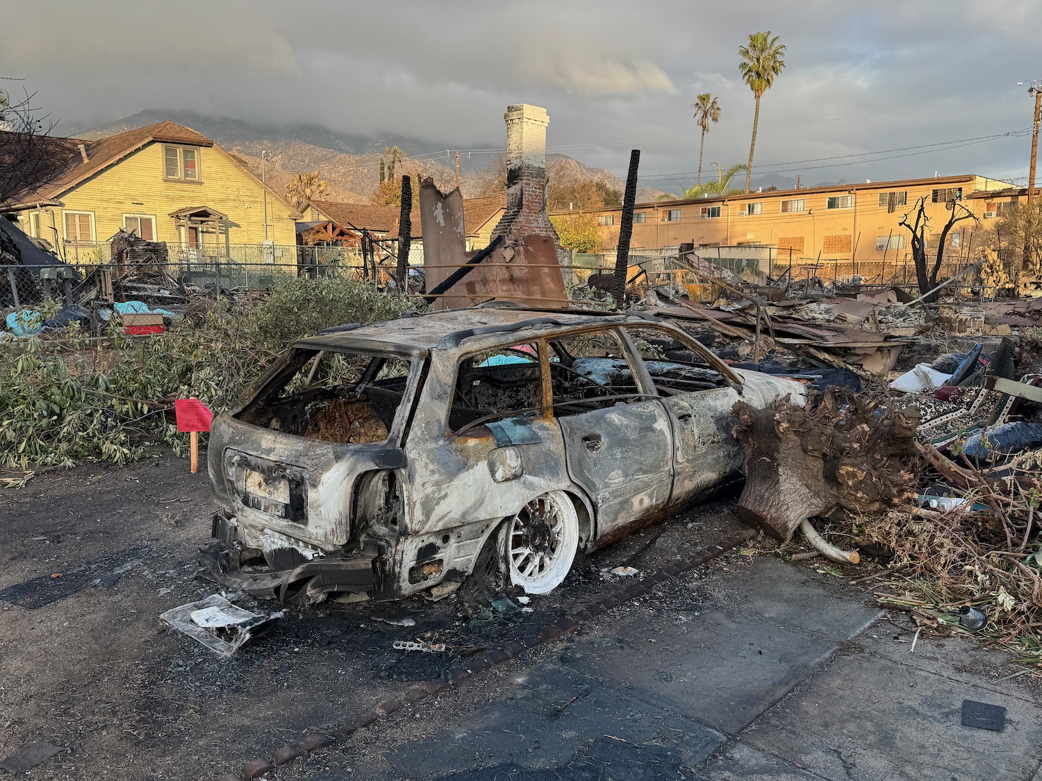 a burned out car in a yard