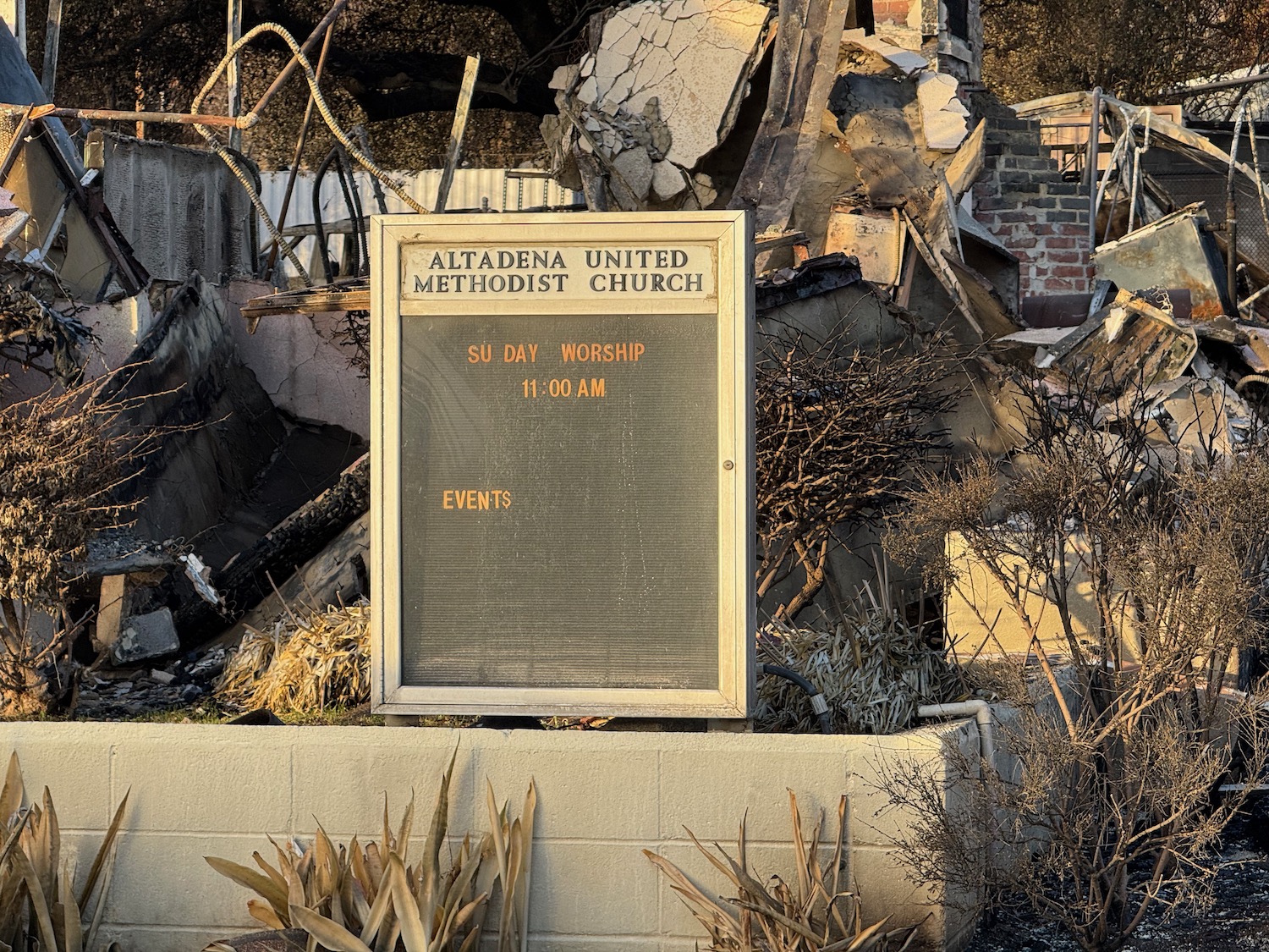 a sign in front of rubble