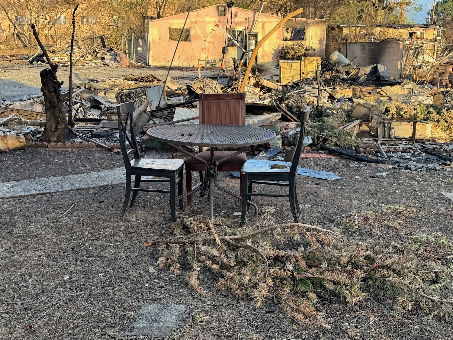 a table and chairs in a yard with debris around it