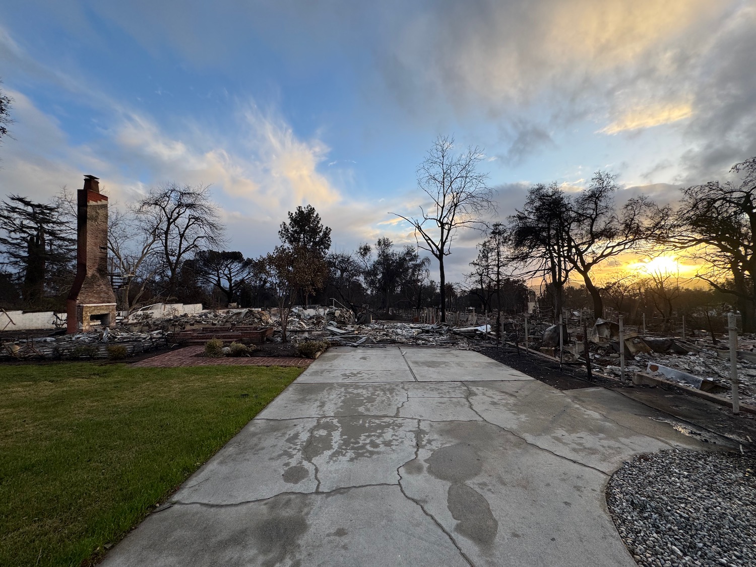 a road with debris on it and a building in the background