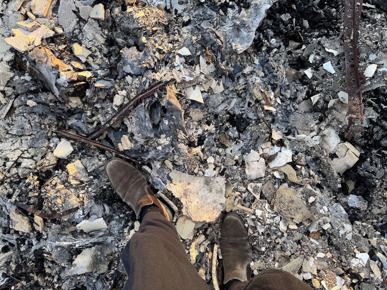 a person's legs in a pile of rocks