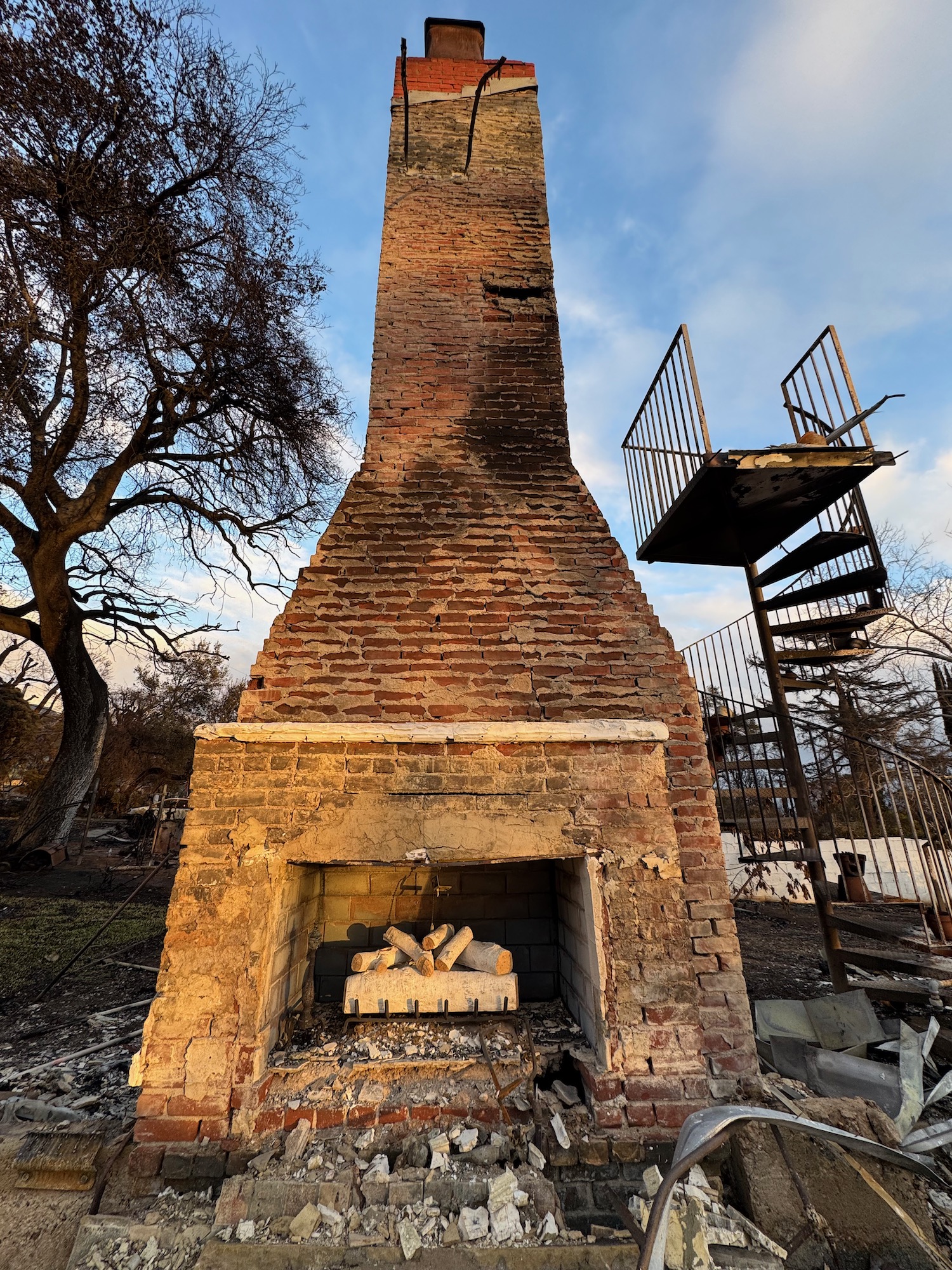 a brick fireplace with a ladder and a metal tower