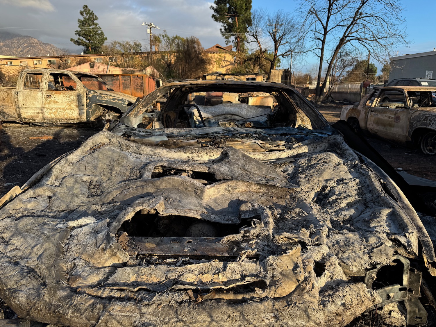 a burned out car in a yard