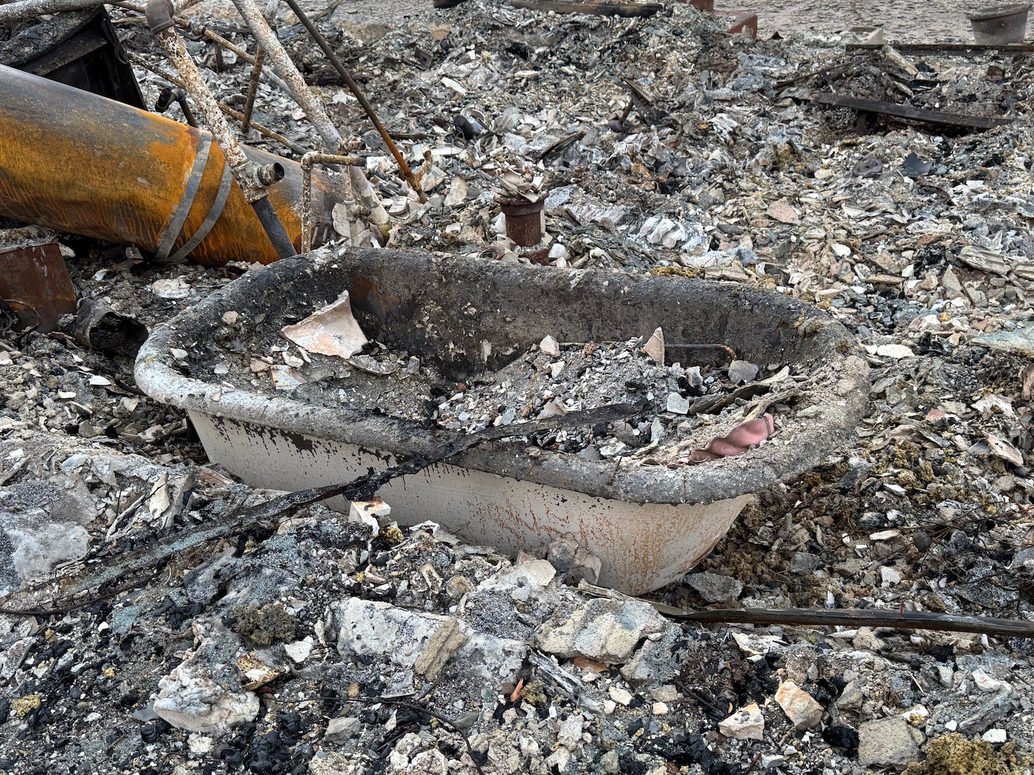 a bathtub in a pile of rubble