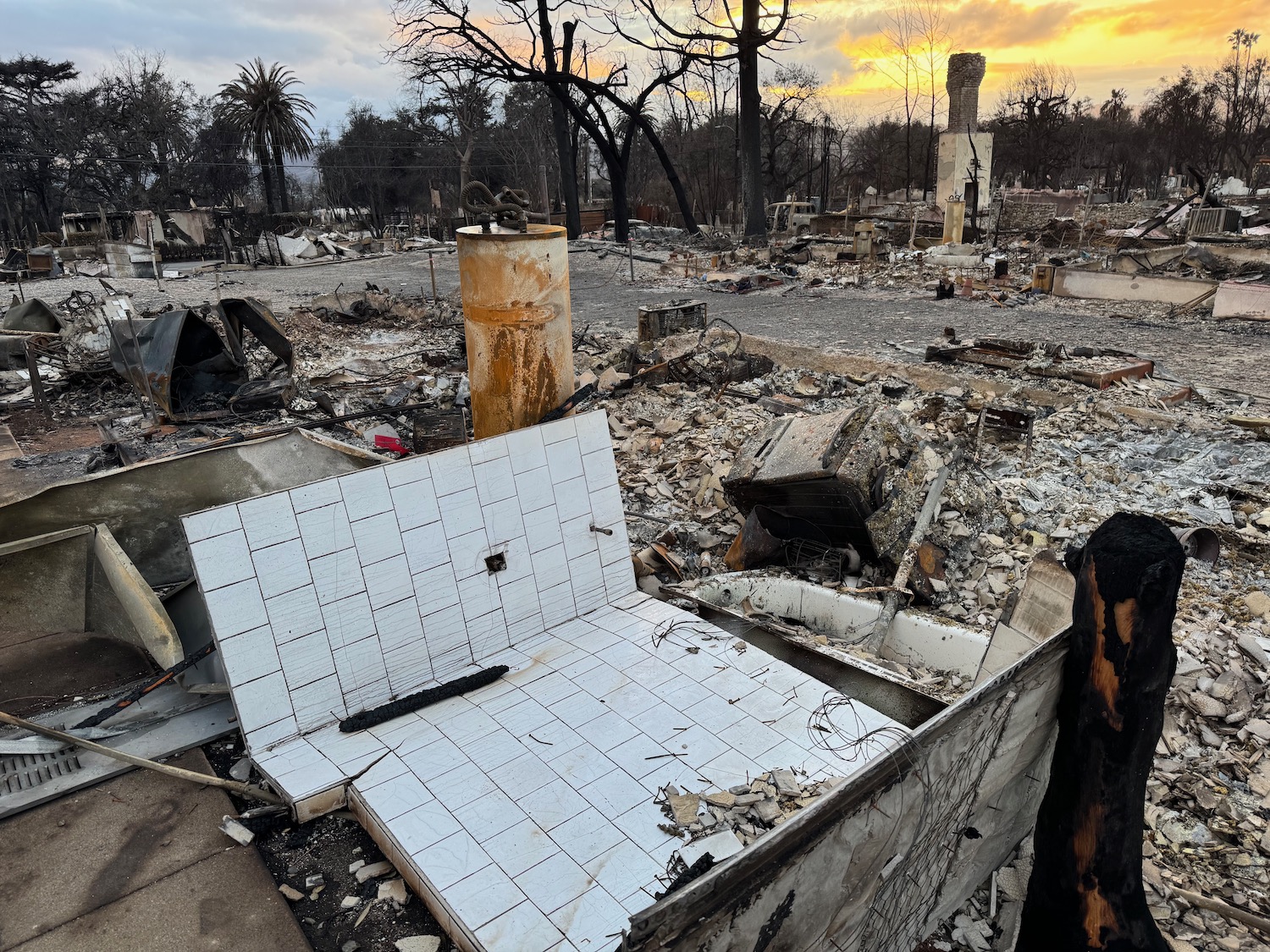 a burned down house with a pile of tiles