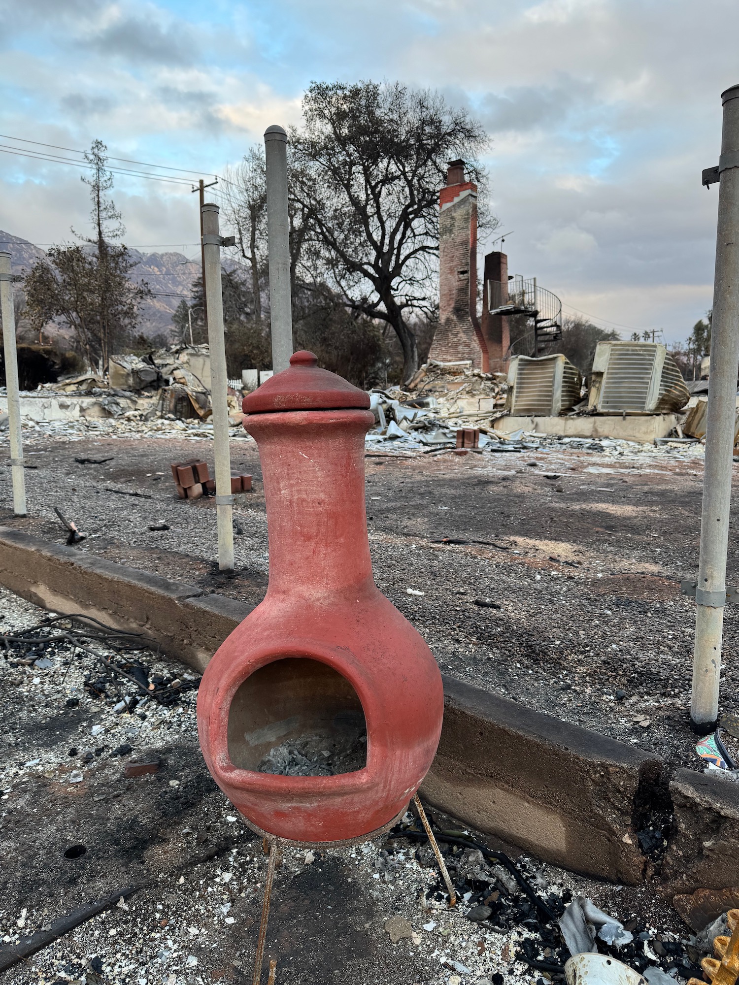 a red fire hydrant in a destroyed area