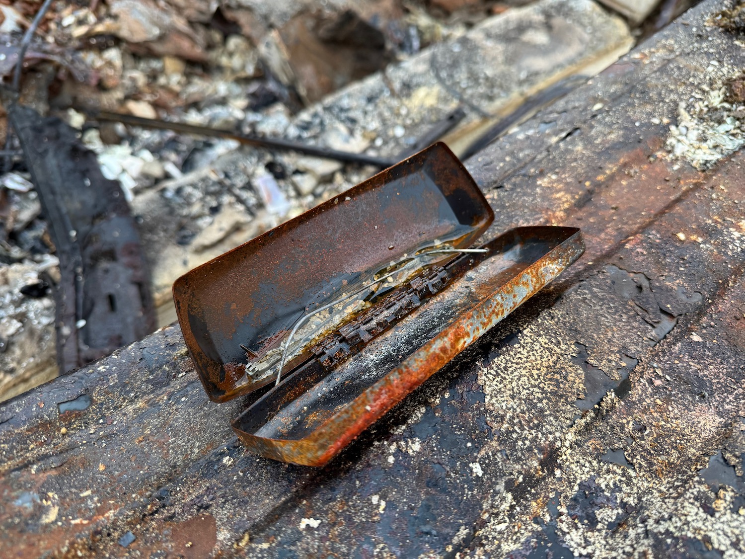 a metal box with a lid on a wood surface