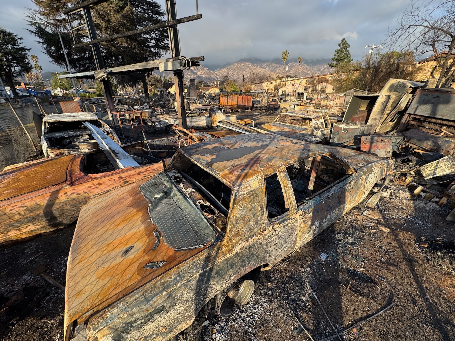 a burned out car in a junk yard