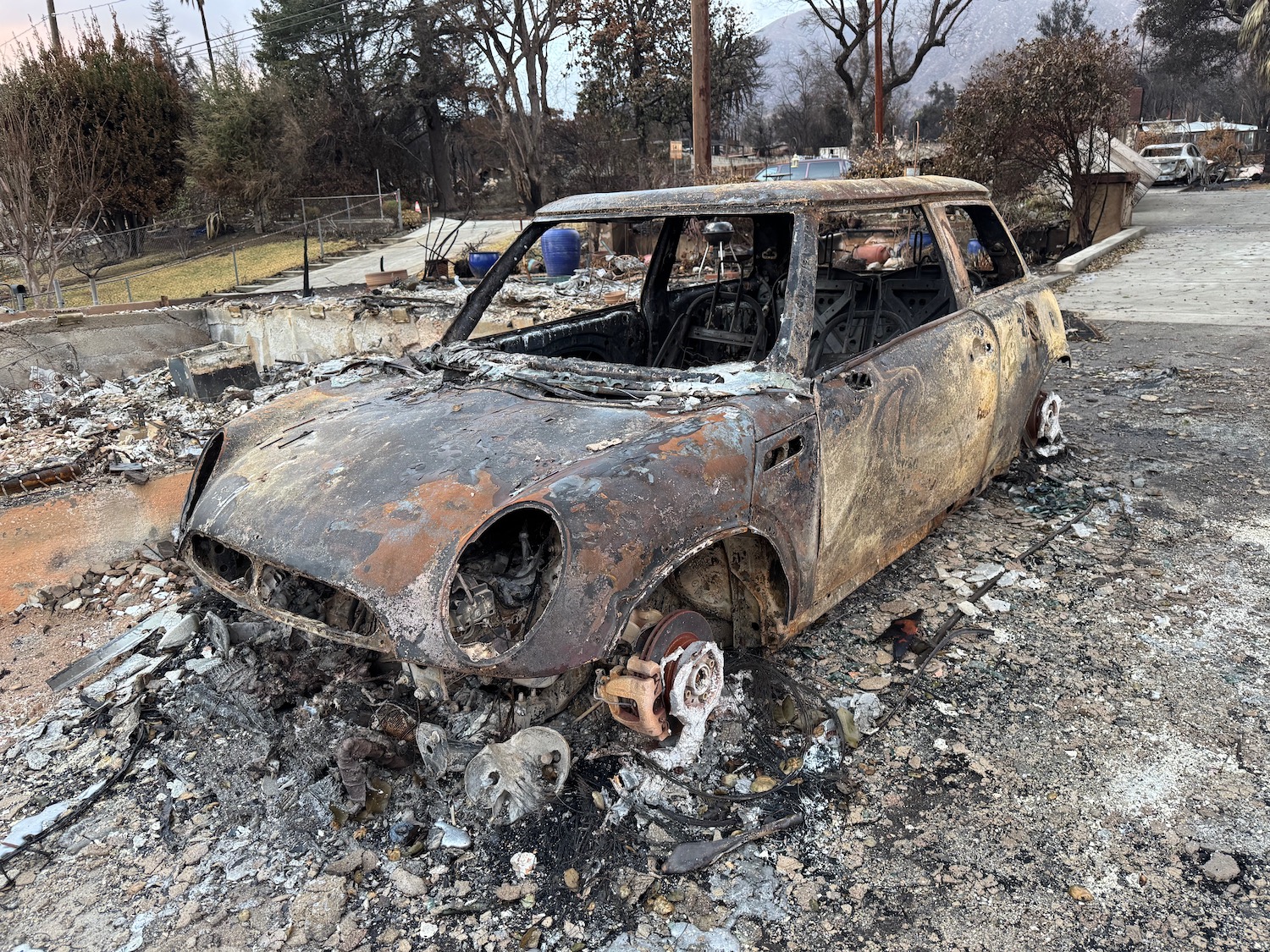 a burned out car in a driveway