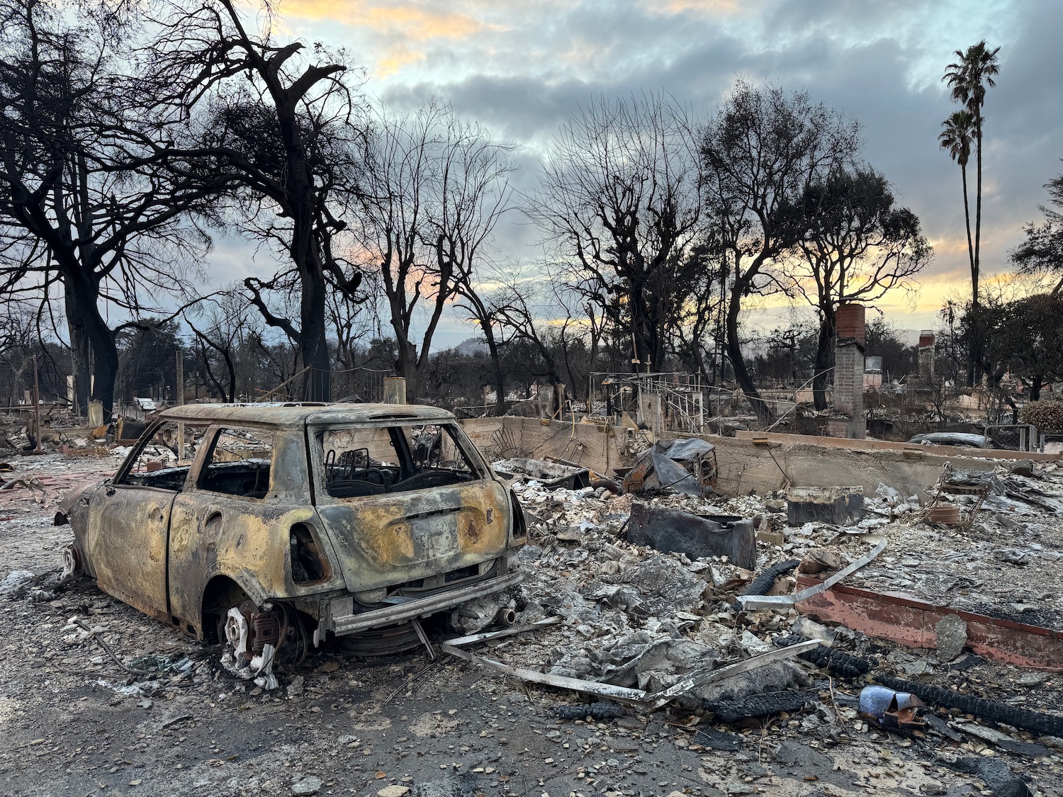 a burned out car in a destroyed area