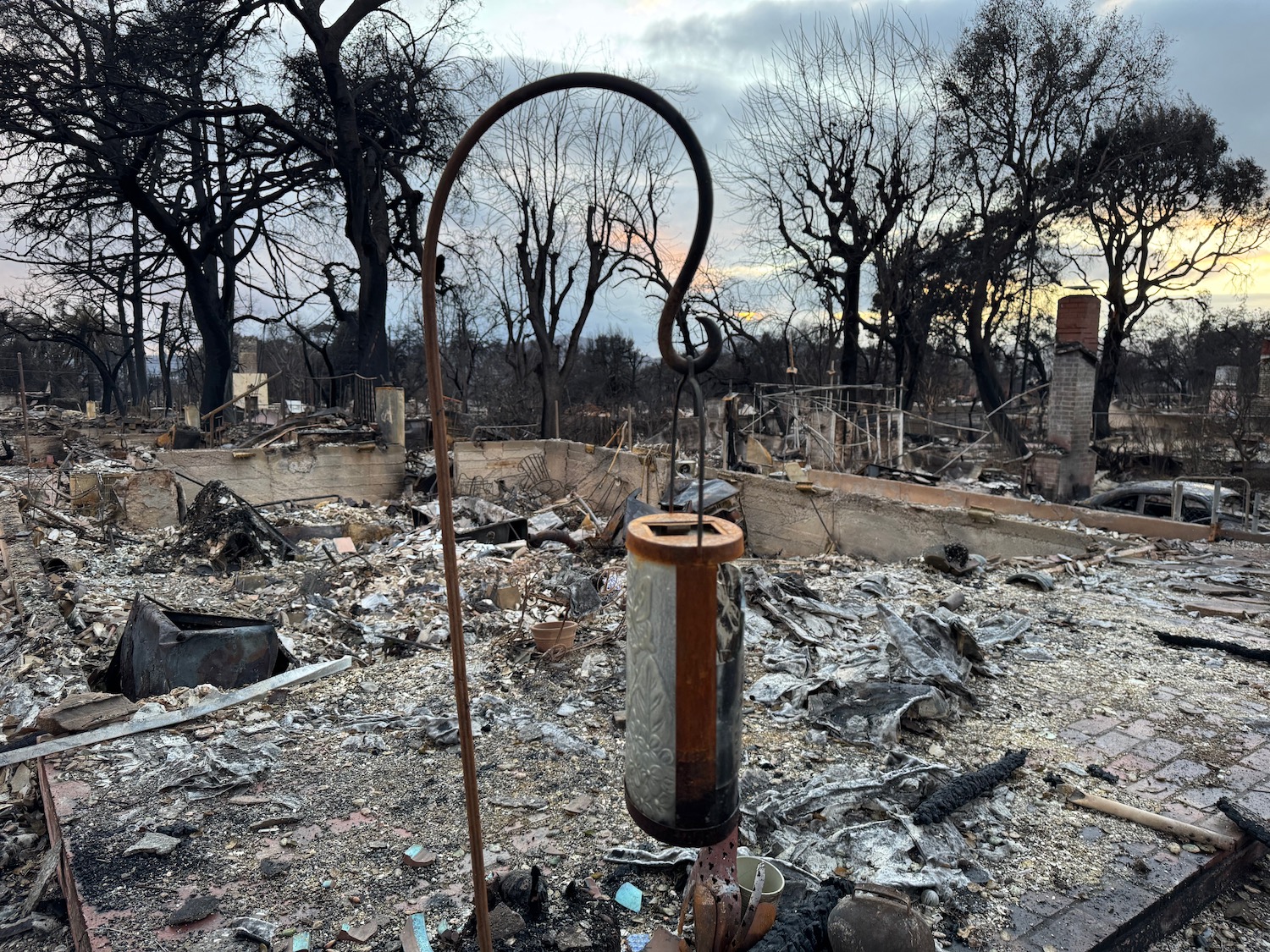 a burned house with a lantern