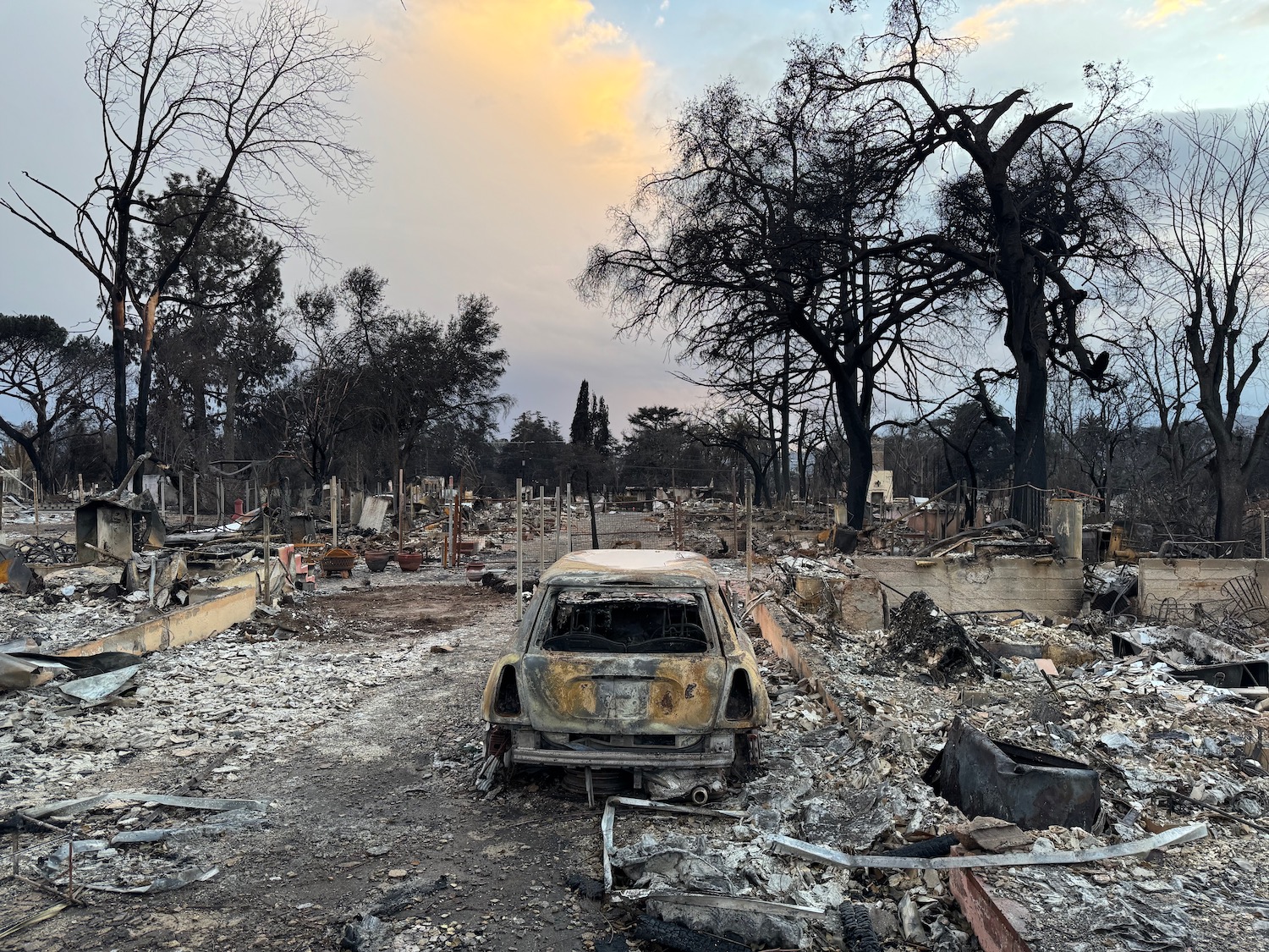 a burned out car in a burned area