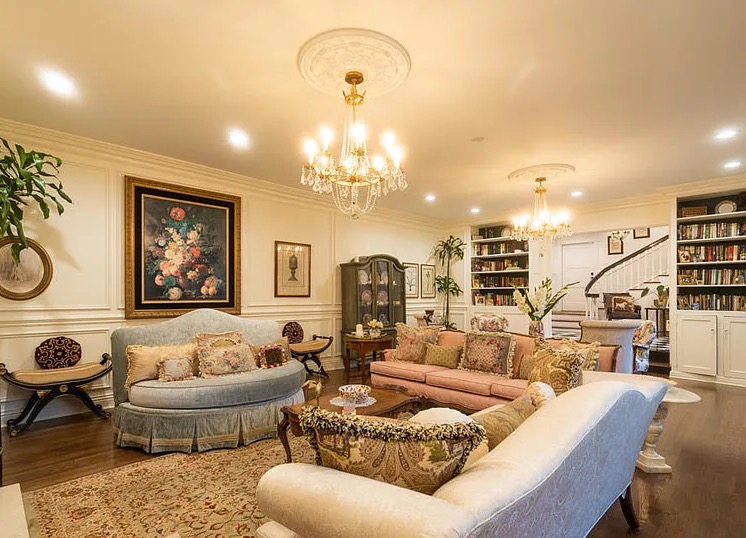 a living room with couches and chandeliers