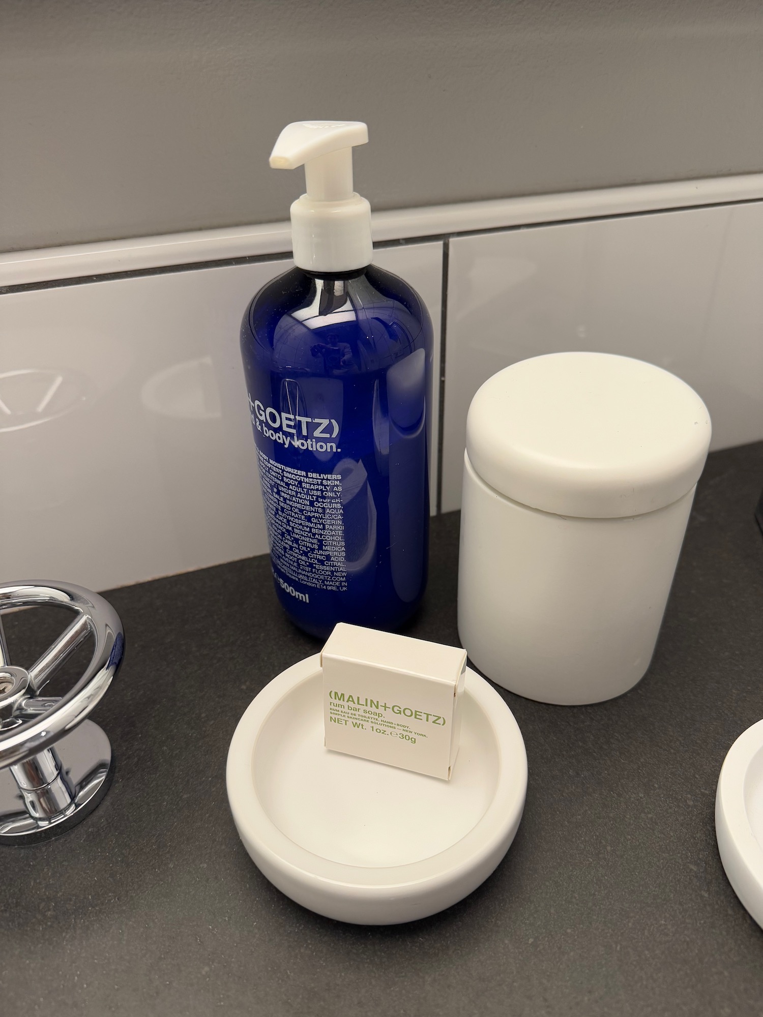 a blue bottle of liquid and a white container on a counter