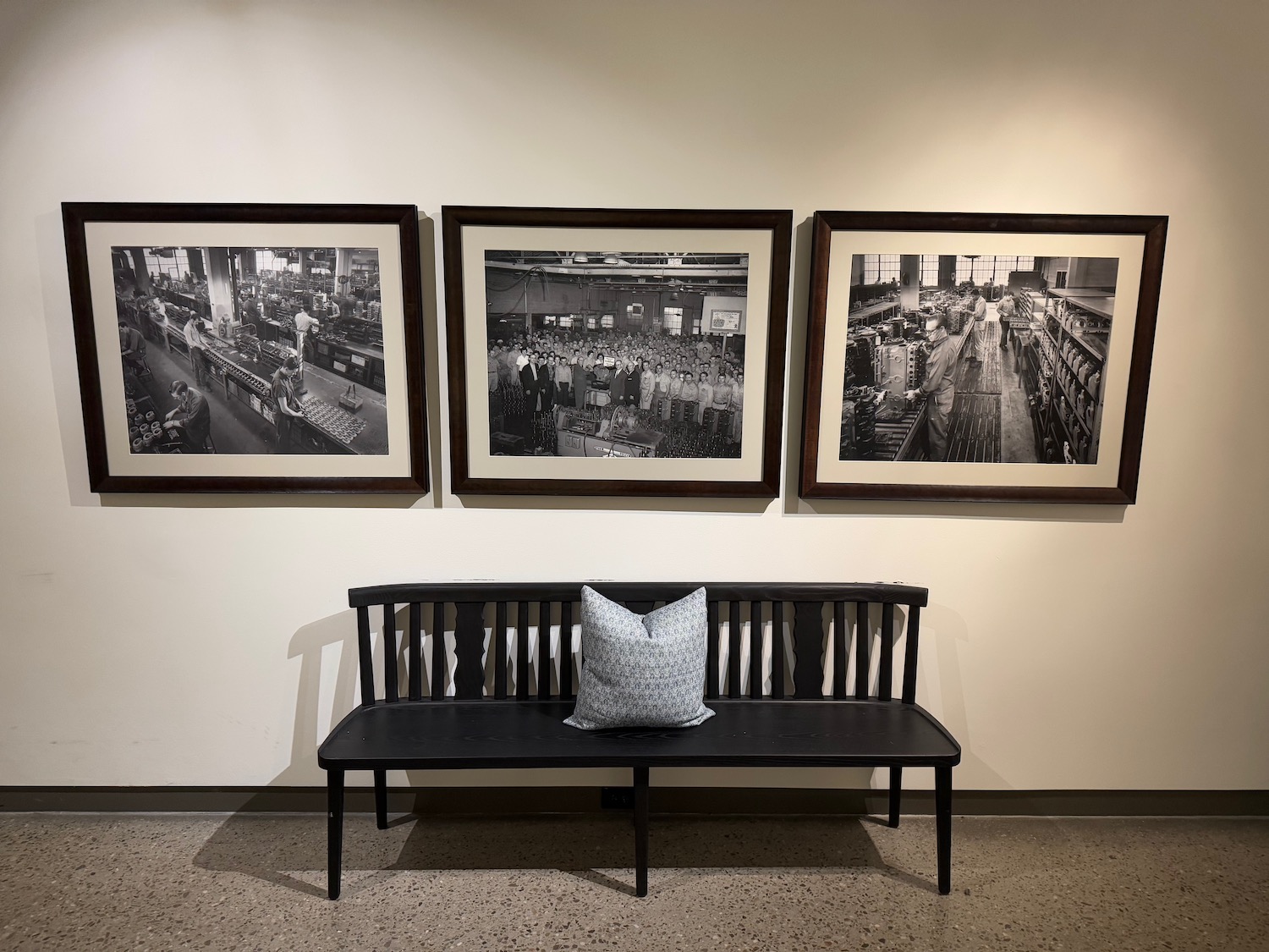 a bench with a pillow on the wall