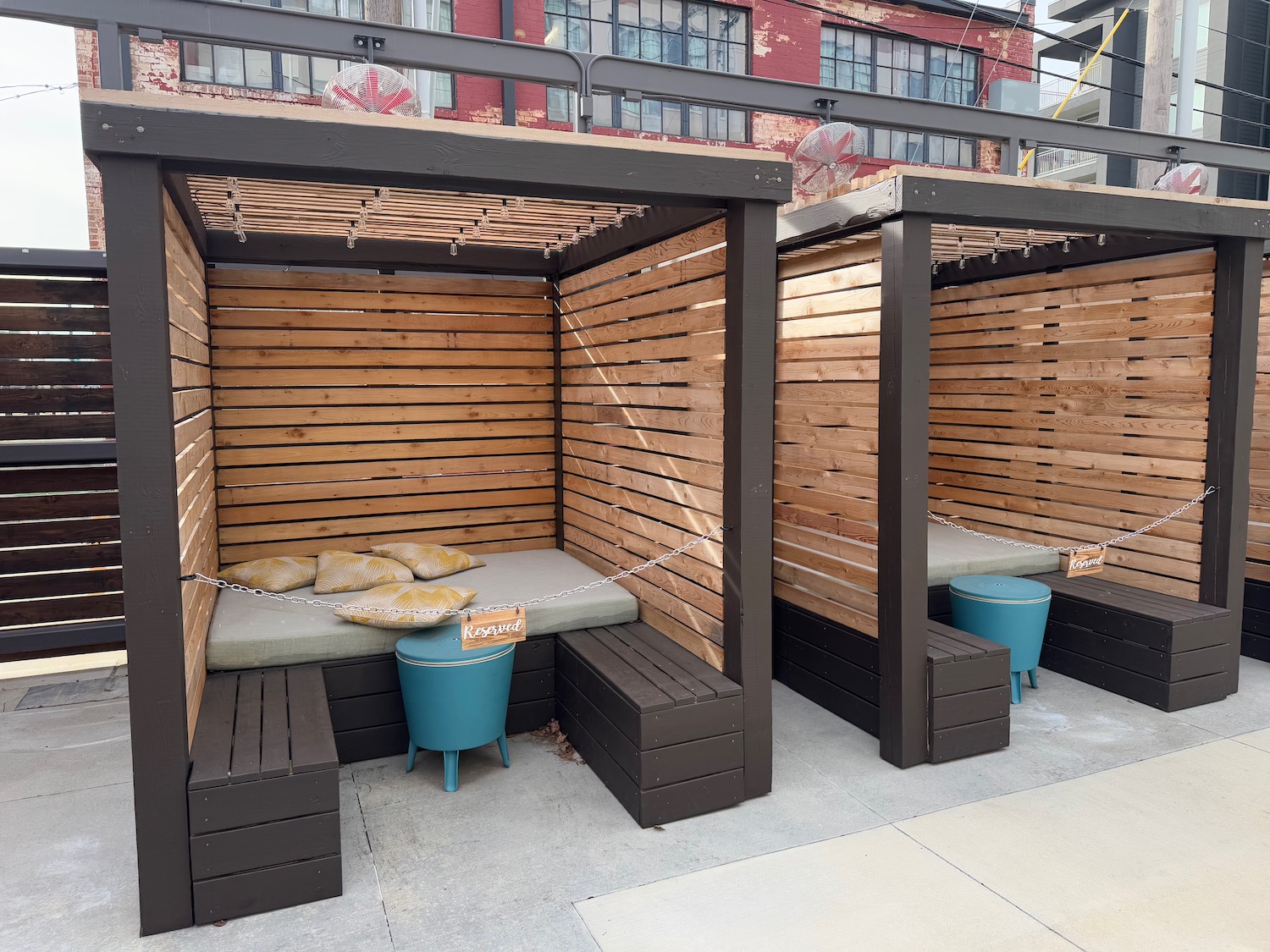 a wooden benches with a bench seat and a blue bucket