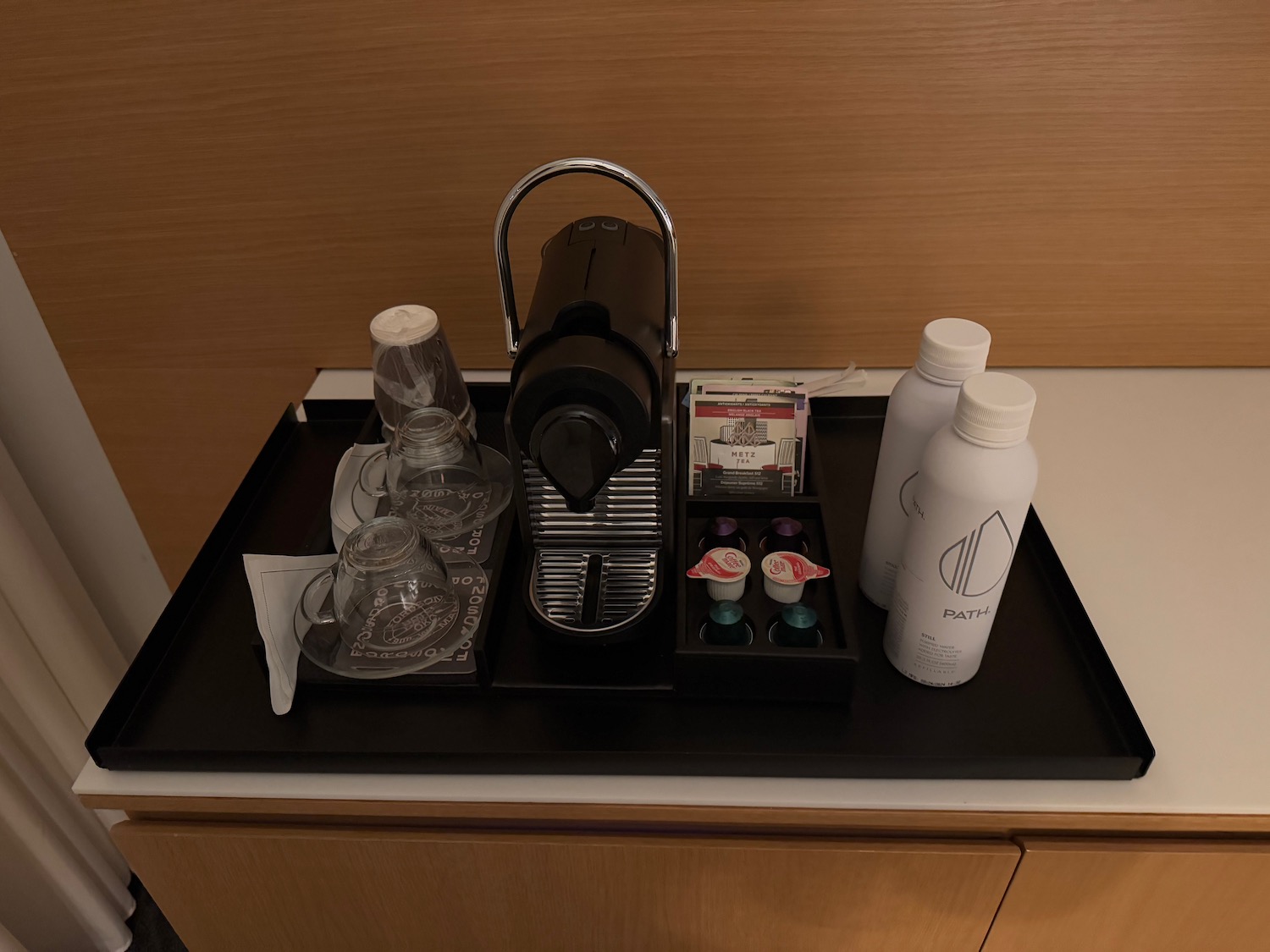 a coffee machine and cups on a tray