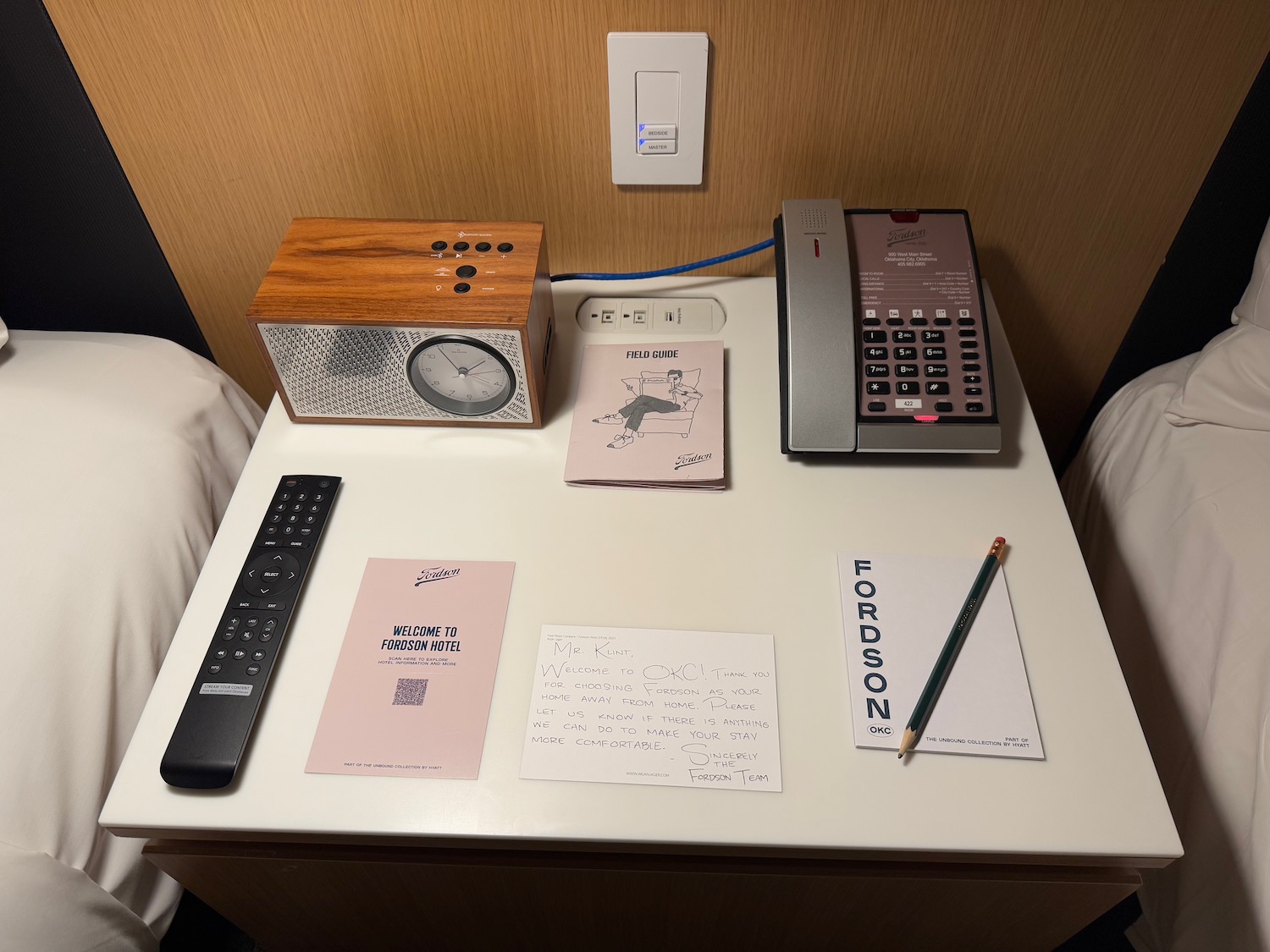 a desk with a telephone and papers and a remote control