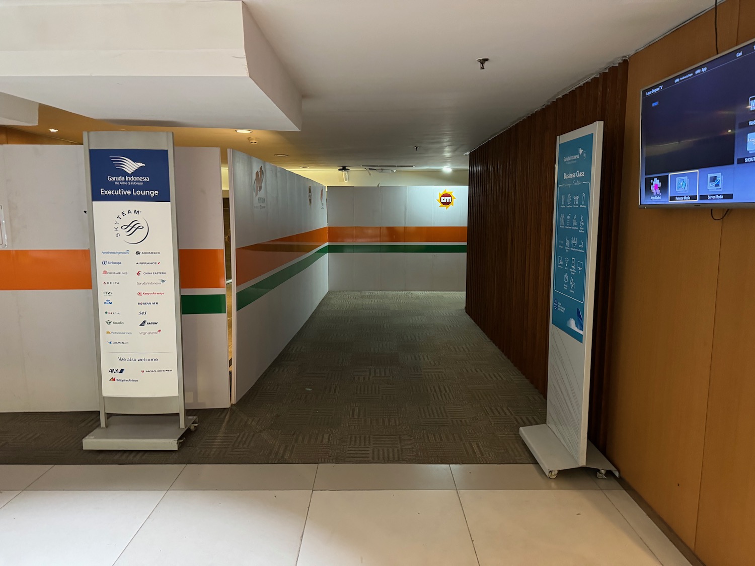 a hallway with a screen and signs