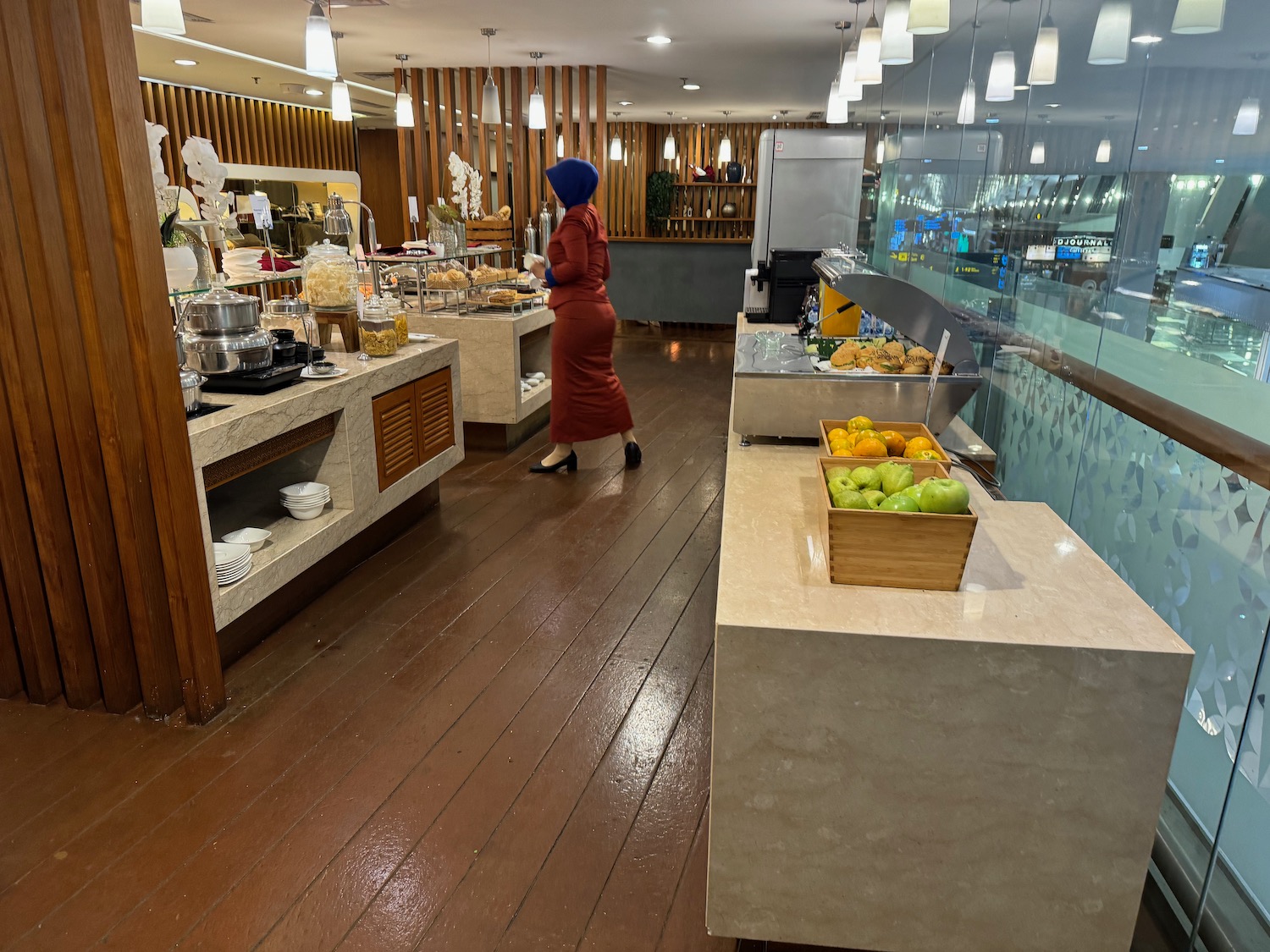 a woman in a red dress standing in a restaurant