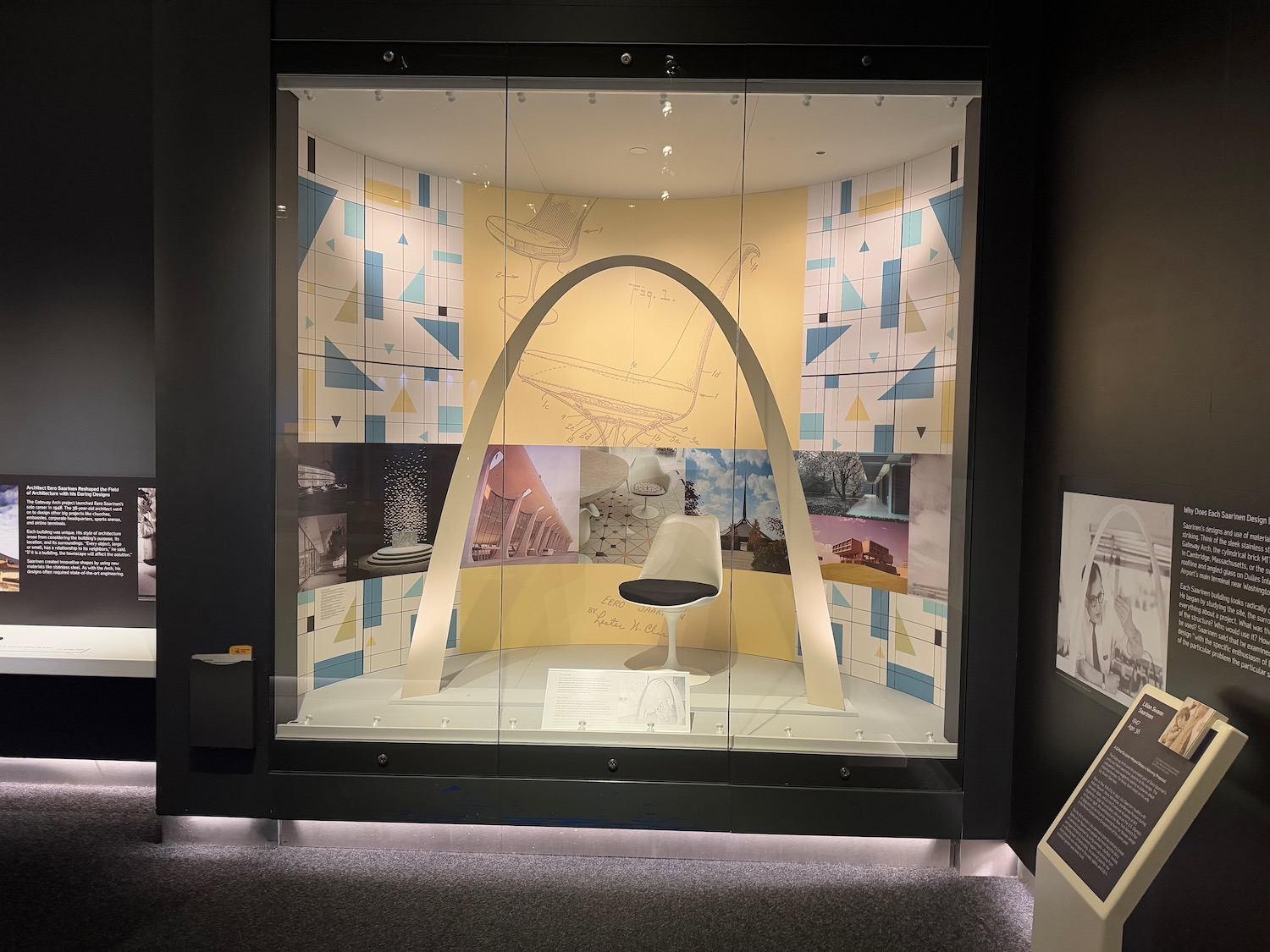 a display case with a chair and a wallpaper