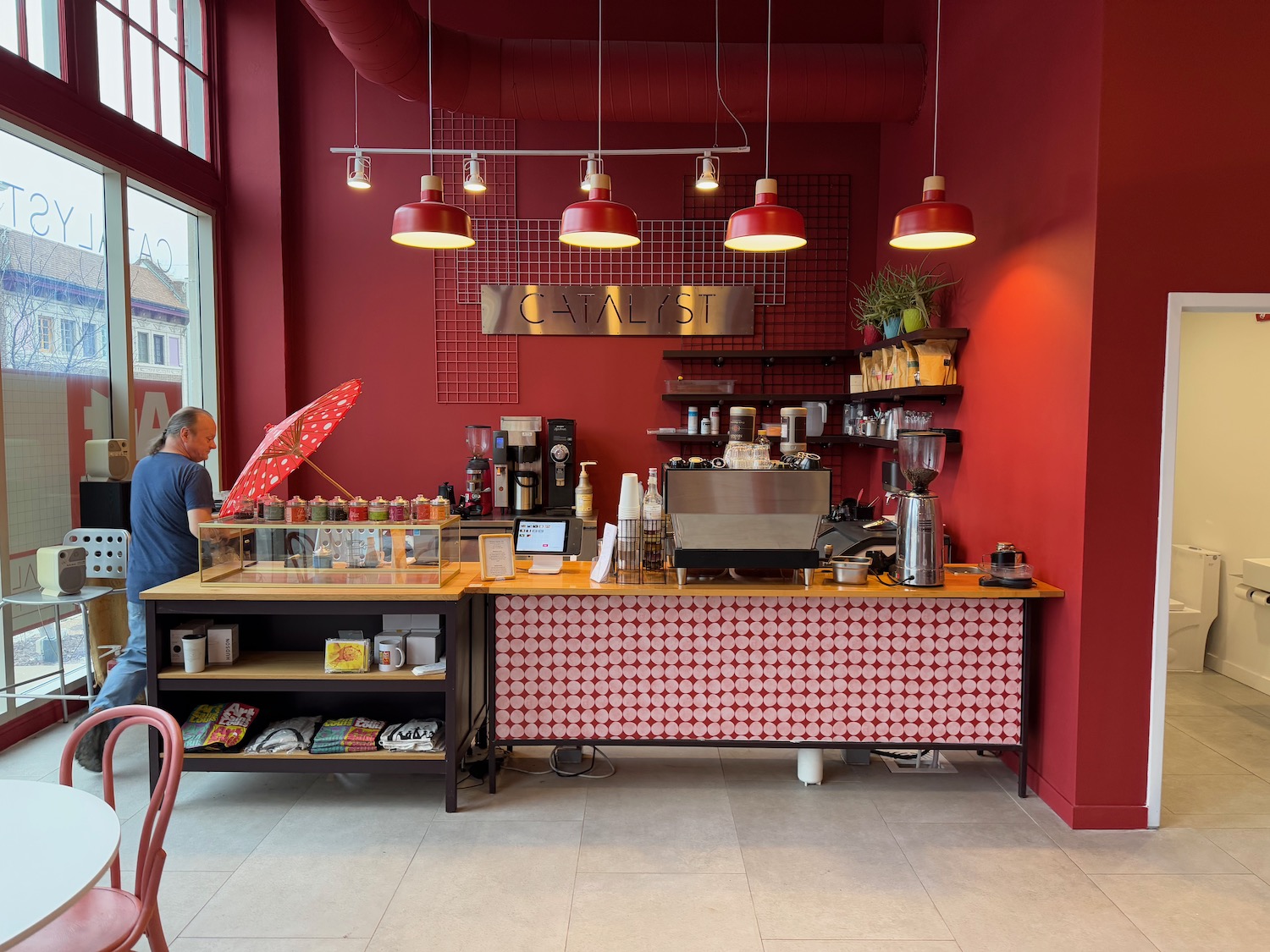 a man standing behind a counter in a red and white room