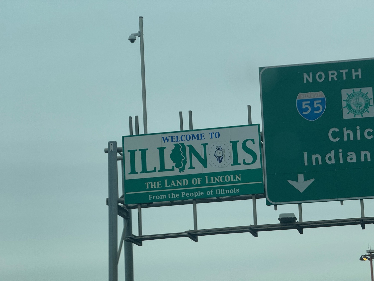 a sign board with a green and white sign