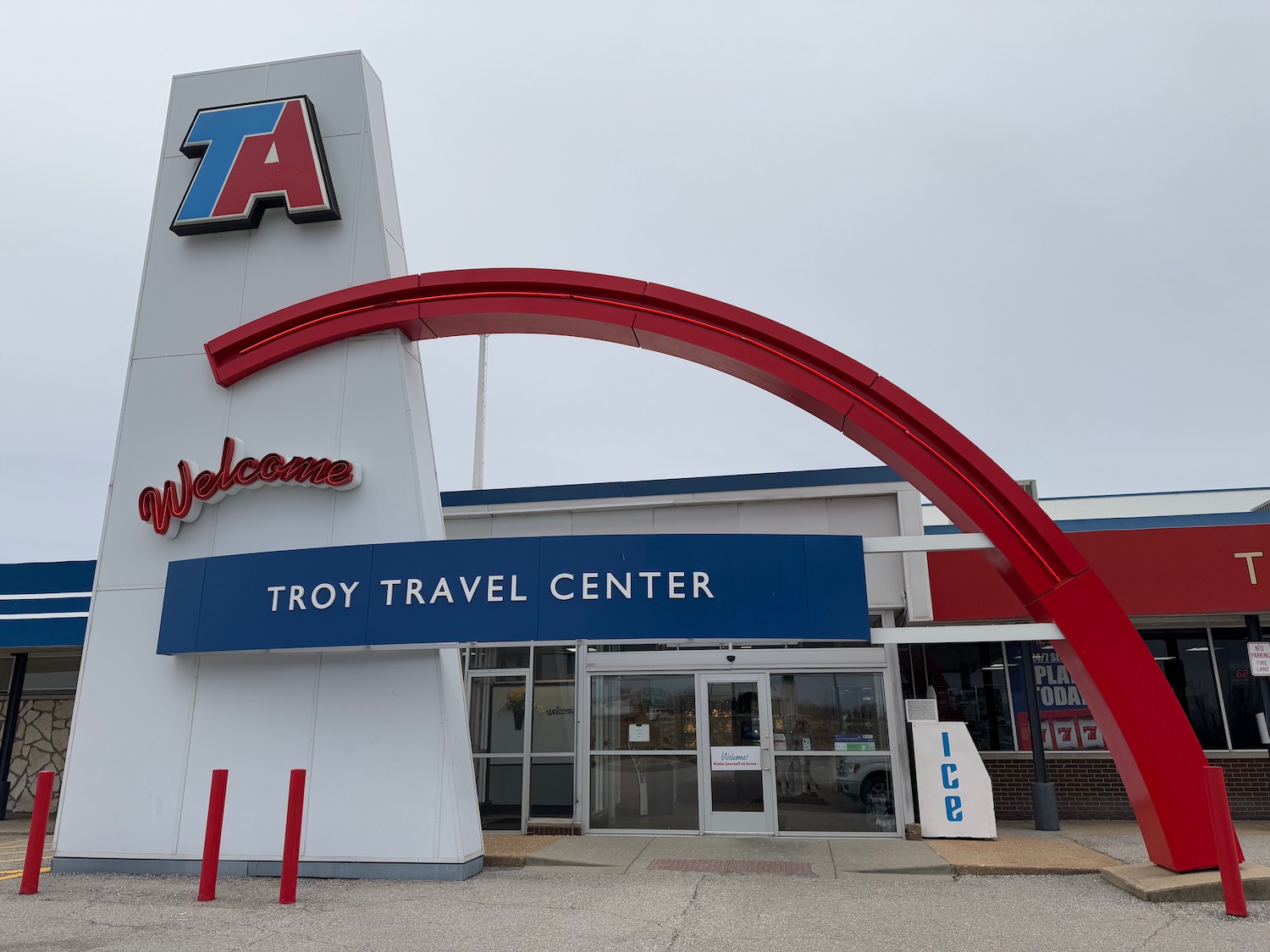 a building with a red arch and blue sign