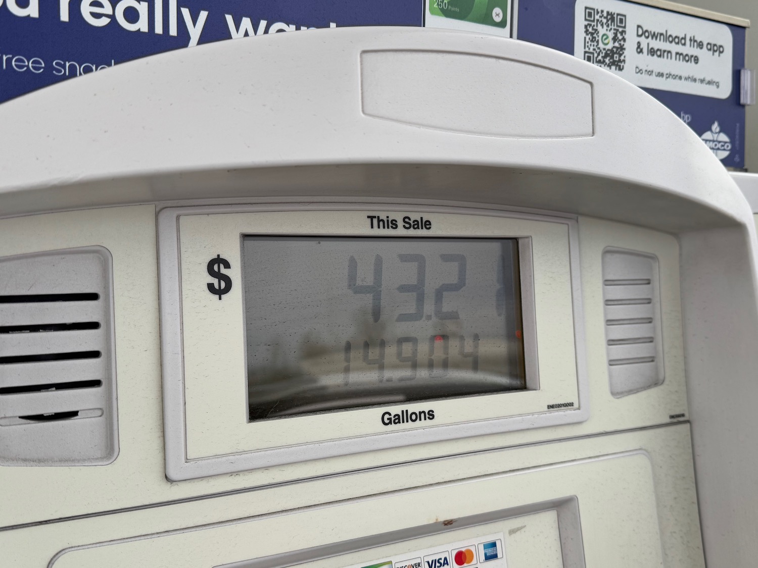 a white gas pump with a screen and numbers on it