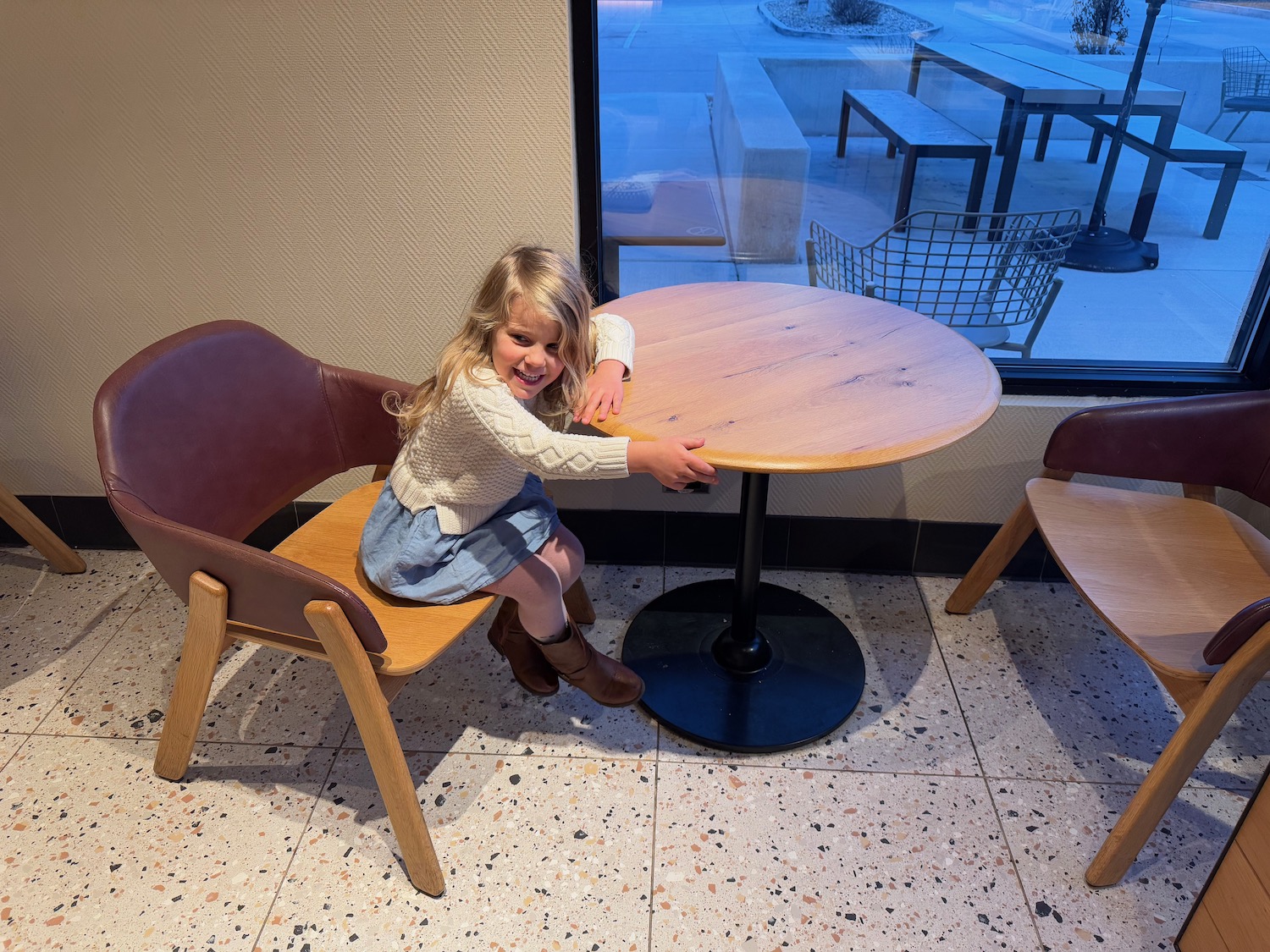 a girl sitting at a table