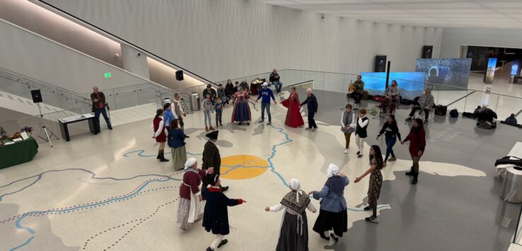 a group of people dancing in a large room