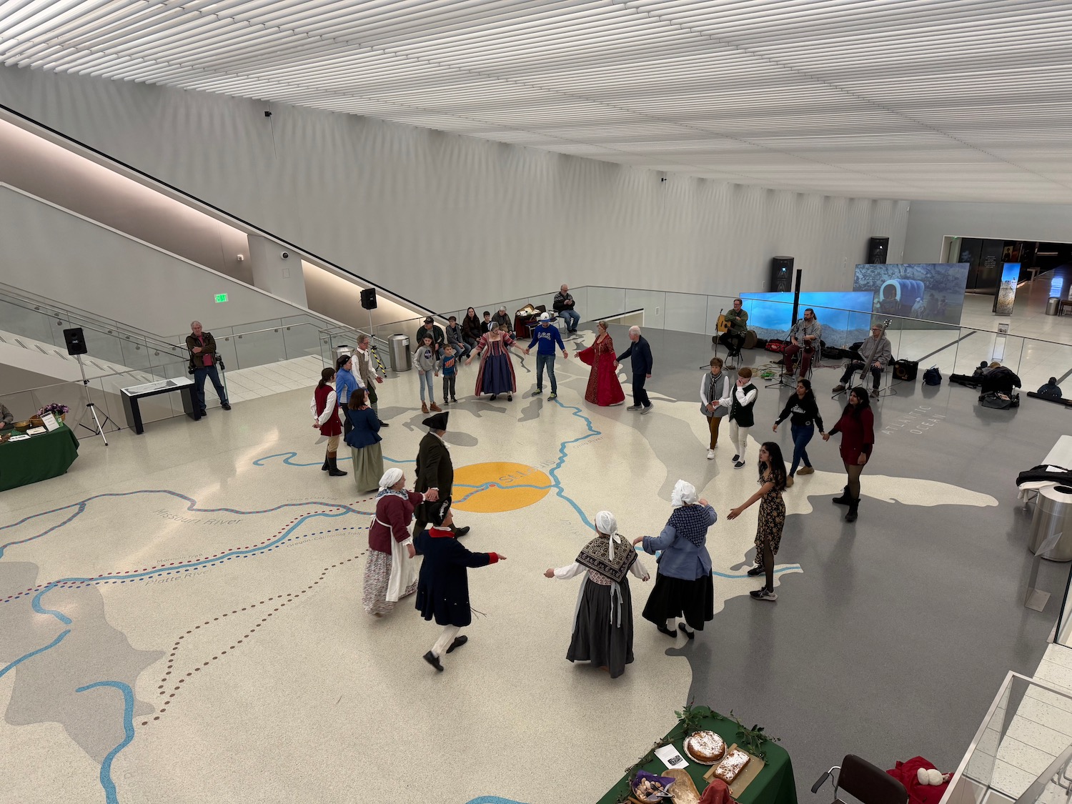 a group of people dancing in a large room