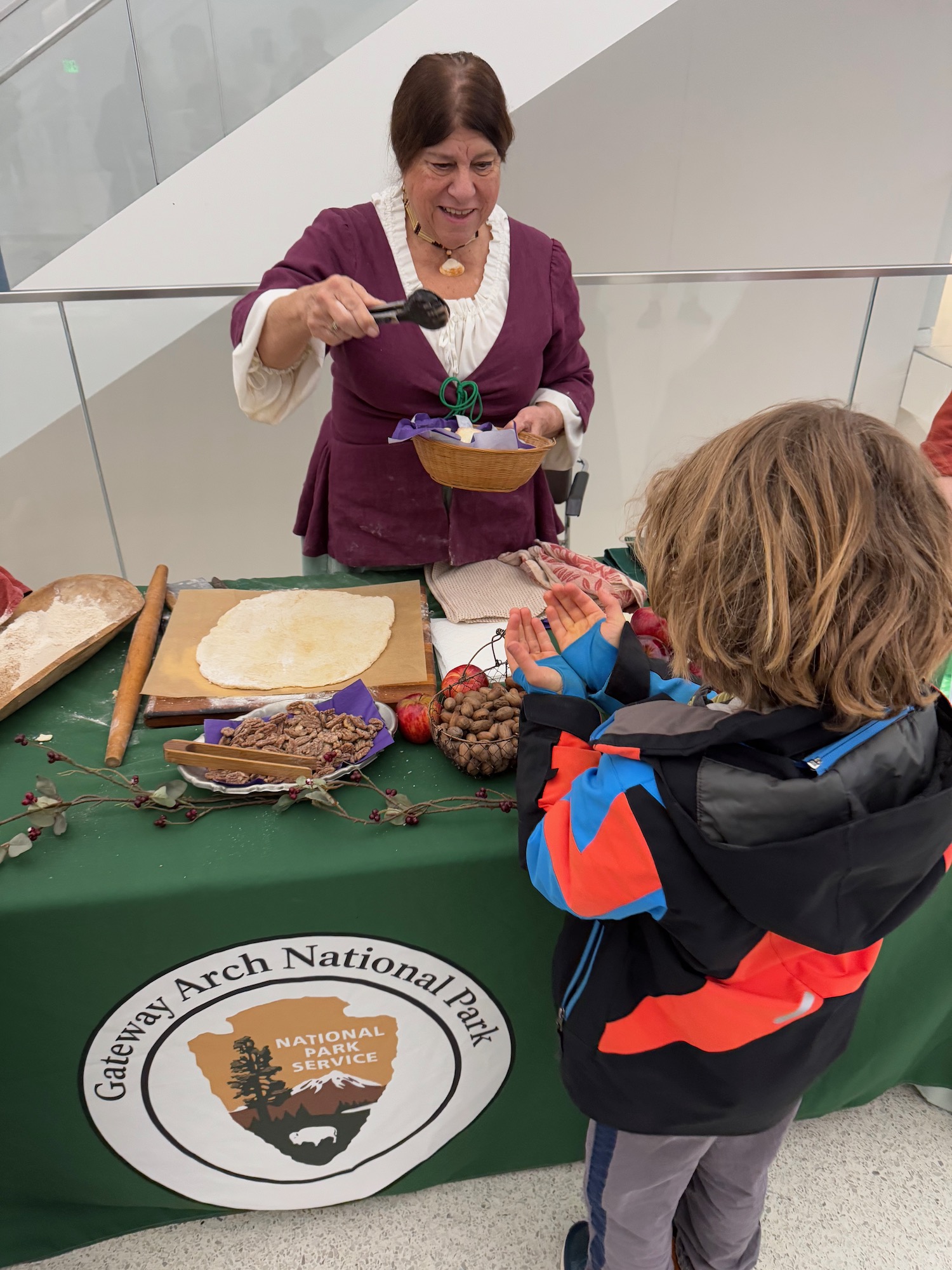 a woman holding a spoon over a bowl of food