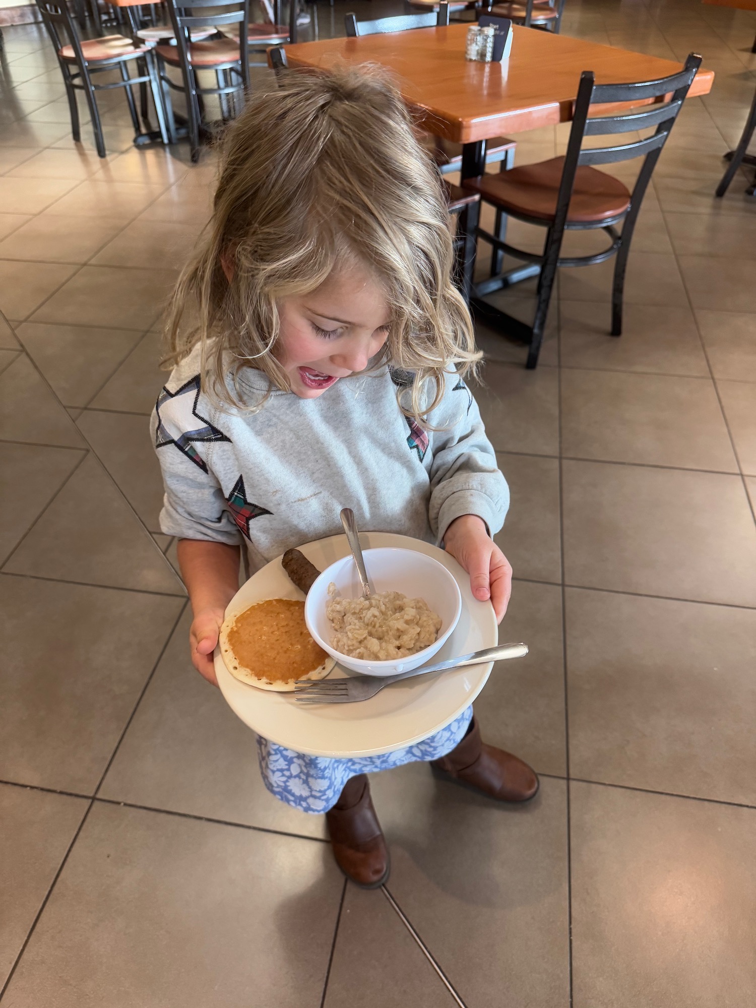 a girl holding a plate of food