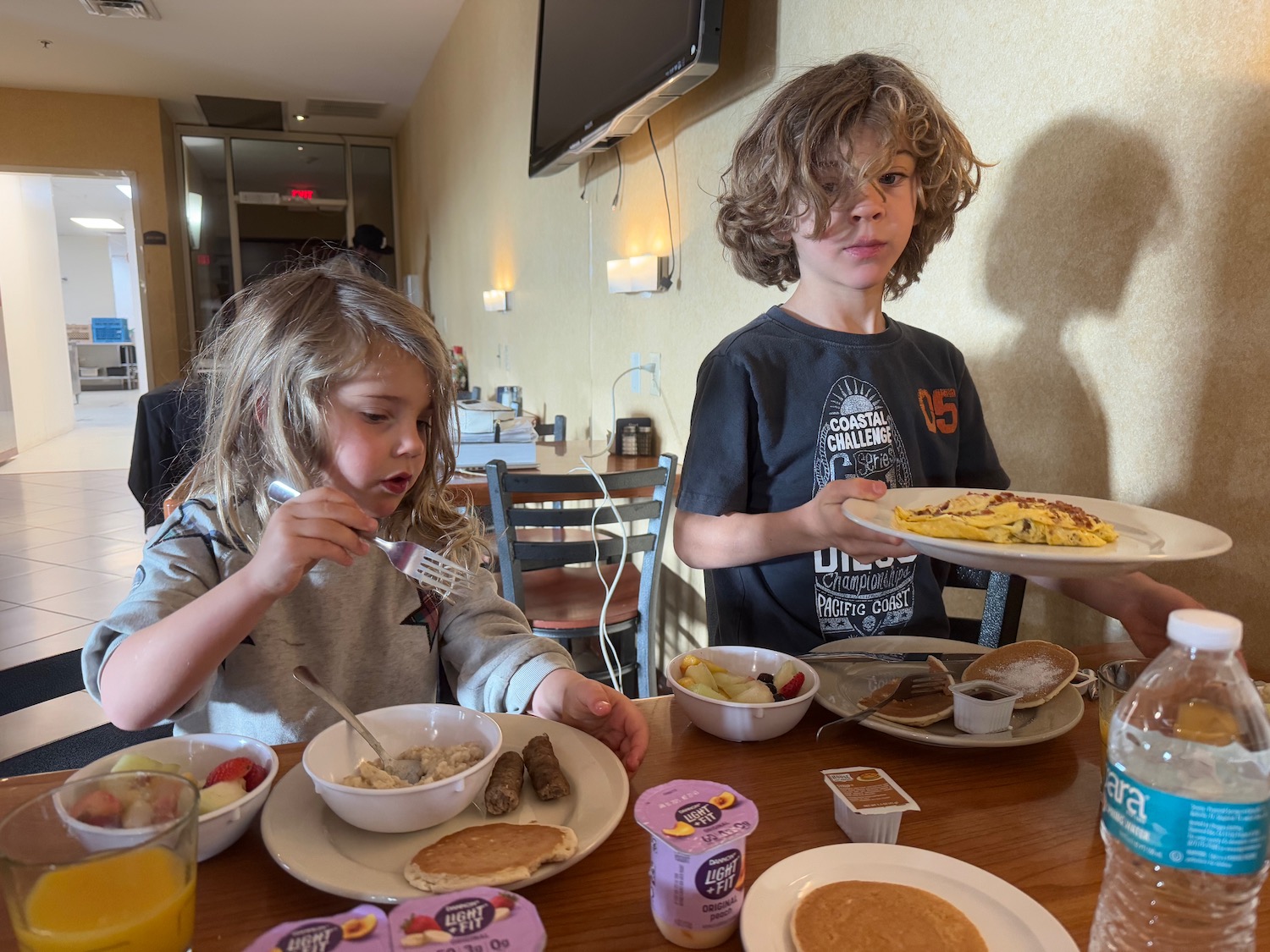 a group of kids eating at a table