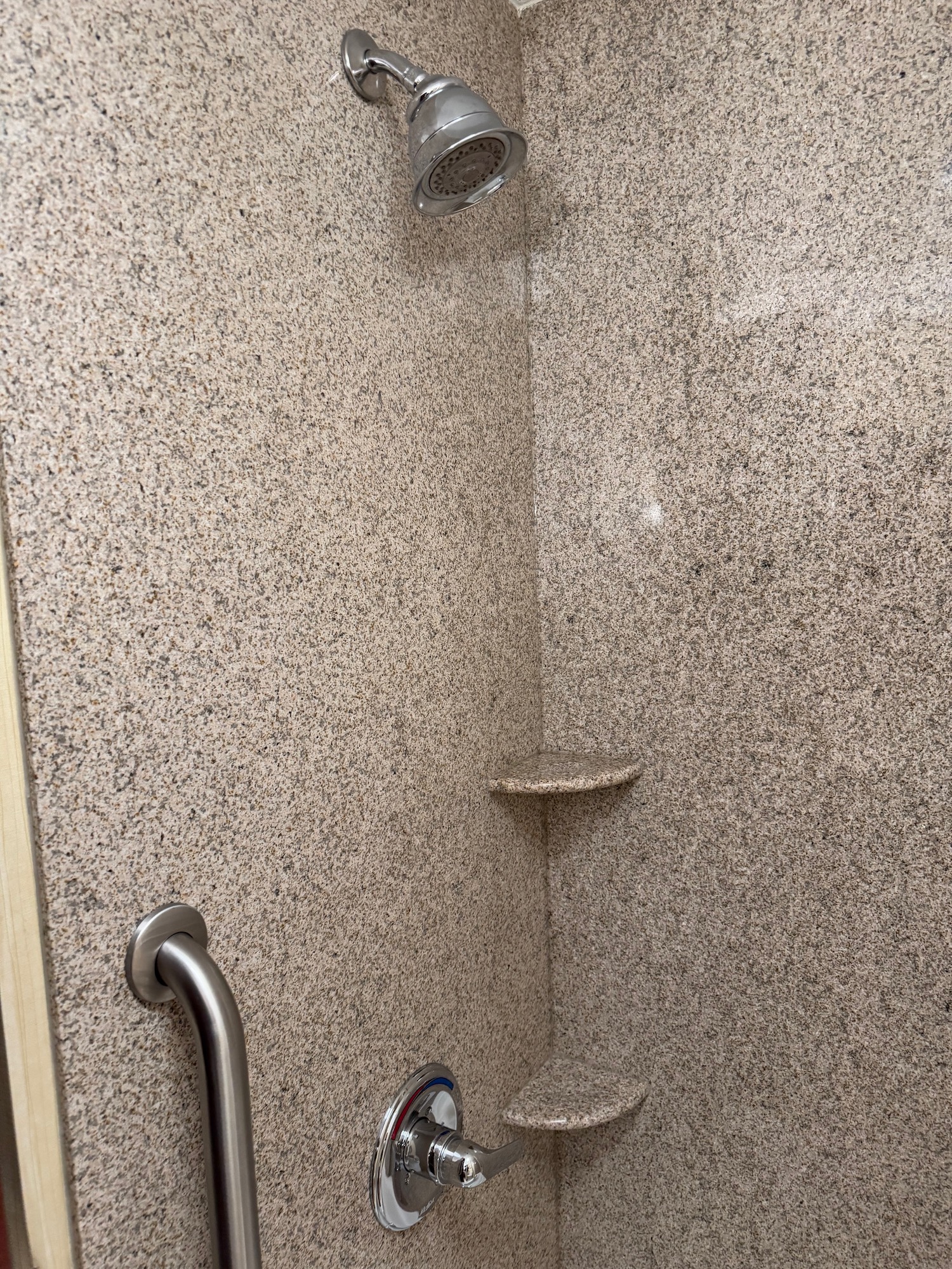 a shower with a shelf