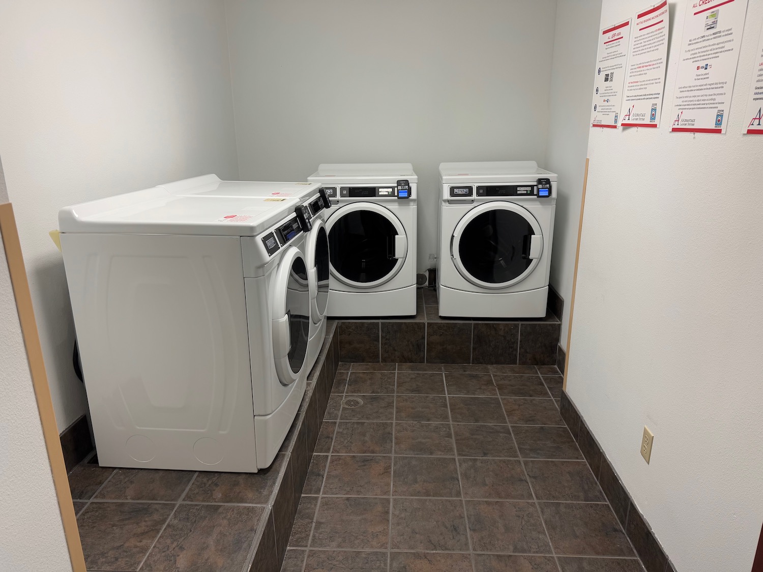 a laundry room with washers and dryers